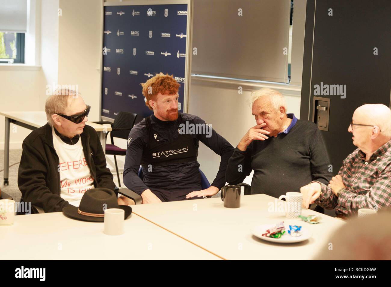 11. September 2025; Dundee and Angus College Gardyne Campus, Dundee, Schottland; Scottish Premiership Football, Dundee Training and Press Conference; Simon Murray of Dundee spricht mit Mitgliedern der Prostate Support Group während ihrer wöchentlichen Sitzung im Gardyne Training Centre Stockfoto