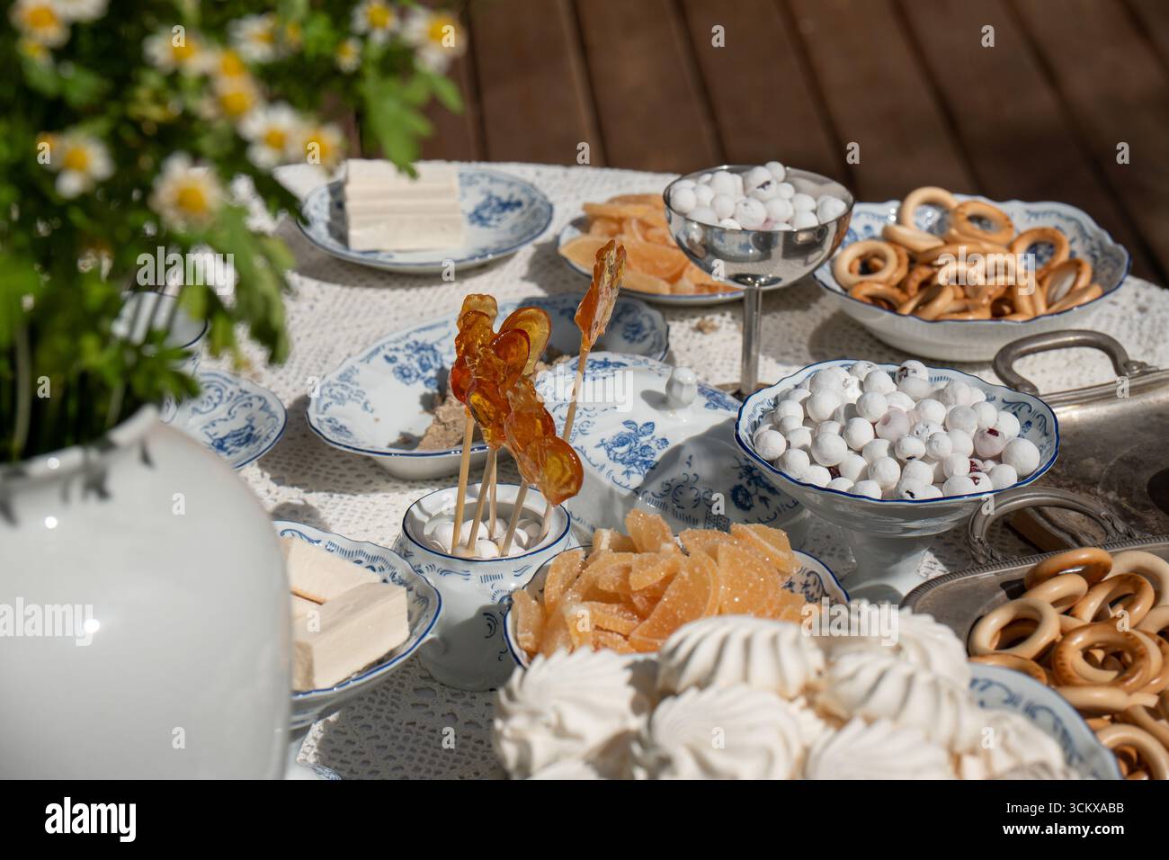 Verschiedene traditionelle russische Süßigkeiten auf eleganten Porzellangerichten: Lutscher, zefir, Marmelade, zuckerbeschichtete Beeren, Bagels, und Marshmallows Stockfoto