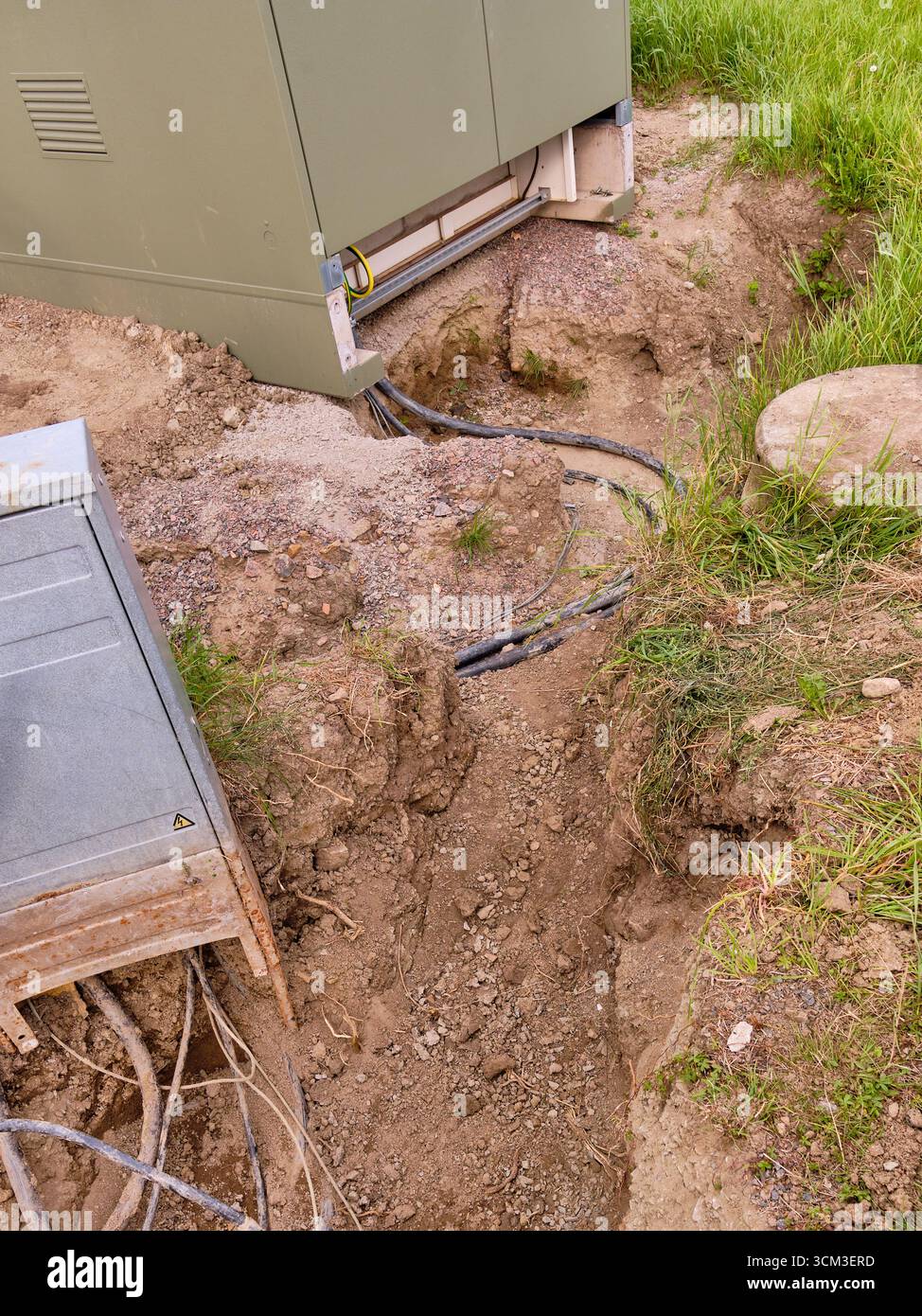 Vistorp, Schweden; 19. August 2023: Nahaufnahme der Trafostation mit offenem Erdgraben und sichtbarem Anschlusskabel. Stockfoto