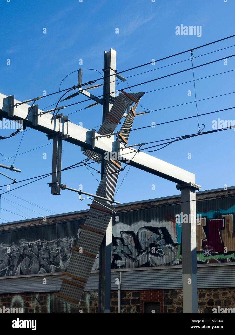 Brunswick, Melbourne, Victoria, Australien. 15. September 2025. Fire Rescue Victoria blockiert die Albion Street, nachdem die Wellpappe bei 75 km/h aus einem nahegelegenen Gebäude abgerissen wurde und Oberleitungen über den Gleisen kurzgeschlossen wurden. Polizei- und U-Bahn-Mitarbeiter sind vor Ort, da der Verkehr und der Zugverkehr gestört werden. Joshua Preston 2025 / Alamy Live News Stockfoto
