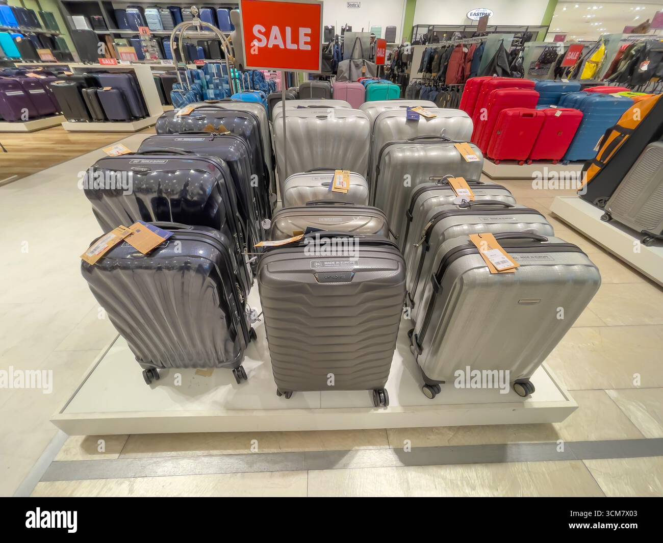 Deutschland Berlin 09.13.2025. Koffer in Silber, Schwarz und Grau sind unter einem Verkaufsschild zu sehen. Das Gepäckdisplay hebt moderne Reisetaschen hervor Stockfoto