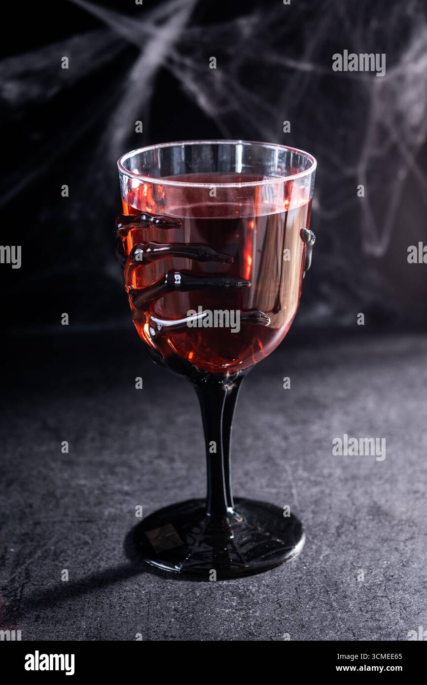 Nahaufnahme eines Halloween-Thementränks, serviert in gruseligen Skelett-Handgläsern Stockfoto