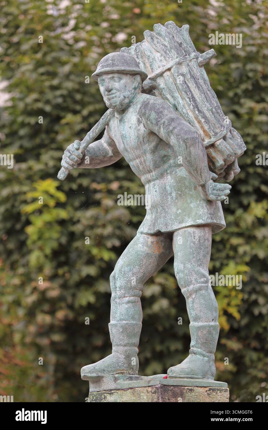 Holzträger von Bernhard Frydag, 1914, männliche Figur mit Korb mit Holz auf dem Rücken, Symbol für Forstwirtschaft, Holzfäller, Holz, Brunnen, wo Stockfoto