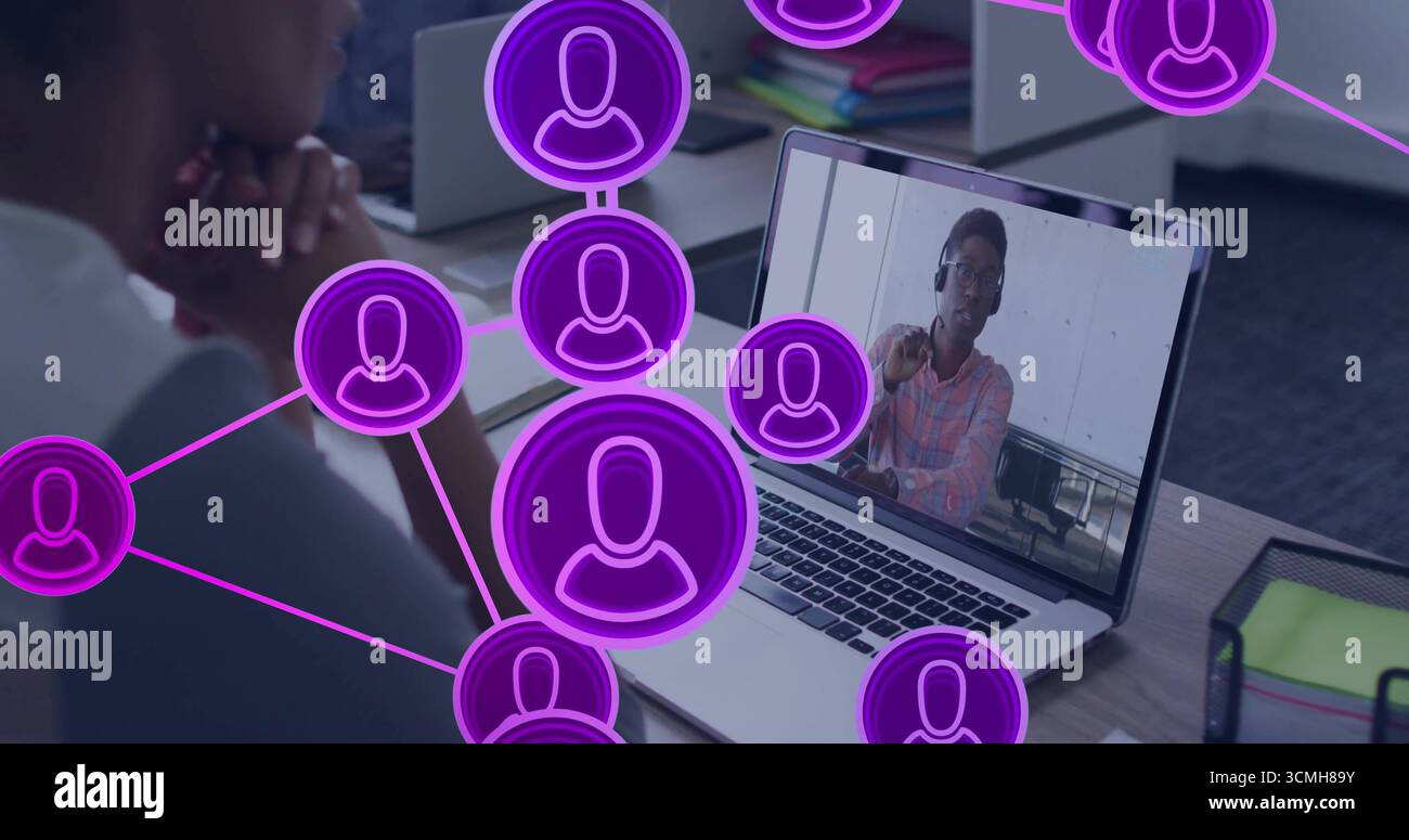 Mitarbeiter beobachten Laptop am Schreibtisch mit violettem Headset-Overlay, auf die Hände gestützt, Kopierraum Stockfoto