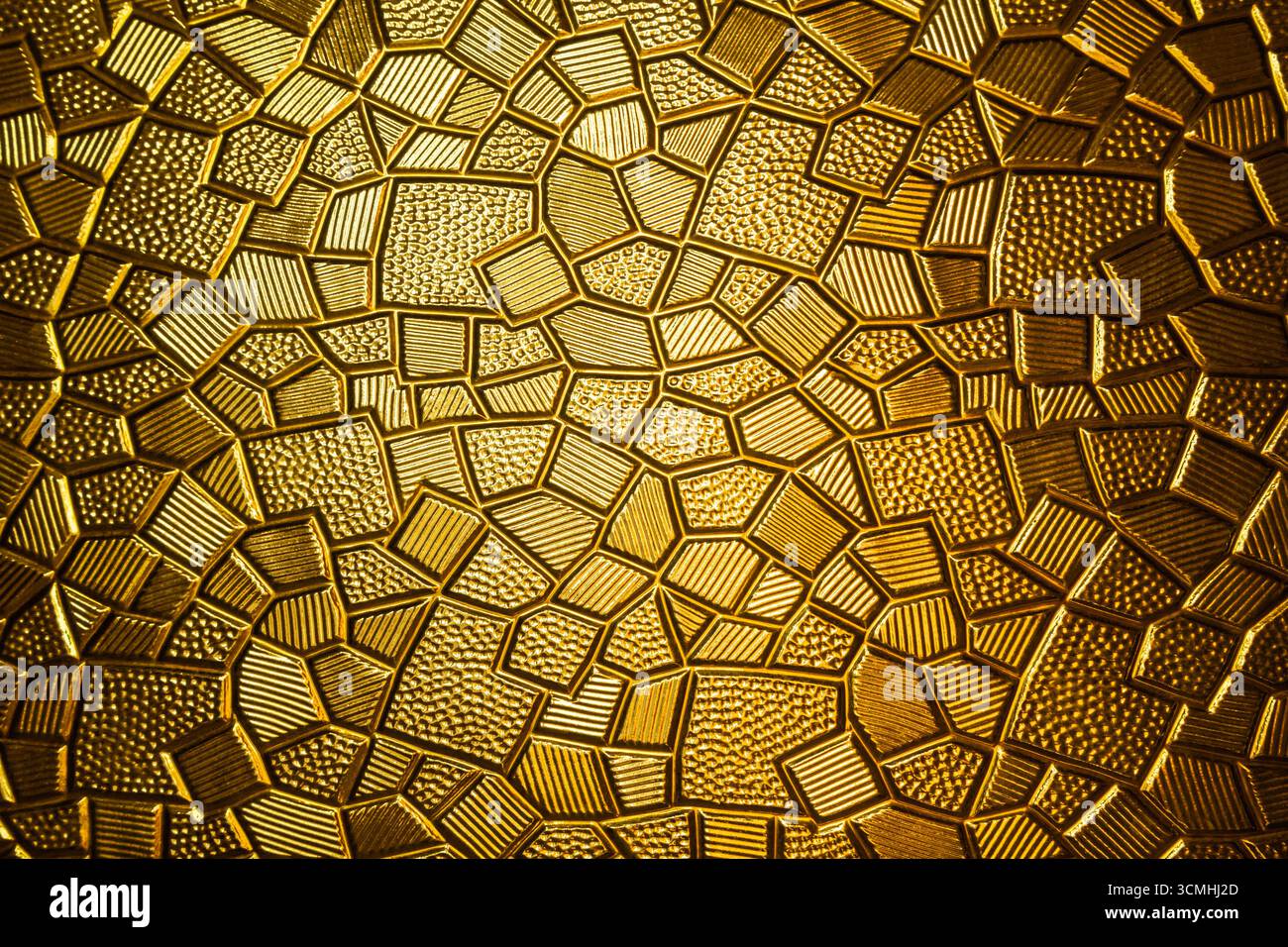 Goldene antike Metallplatte mit polygonaler Textur und geometrischem Muster, Nahaufnahme Stockfoto