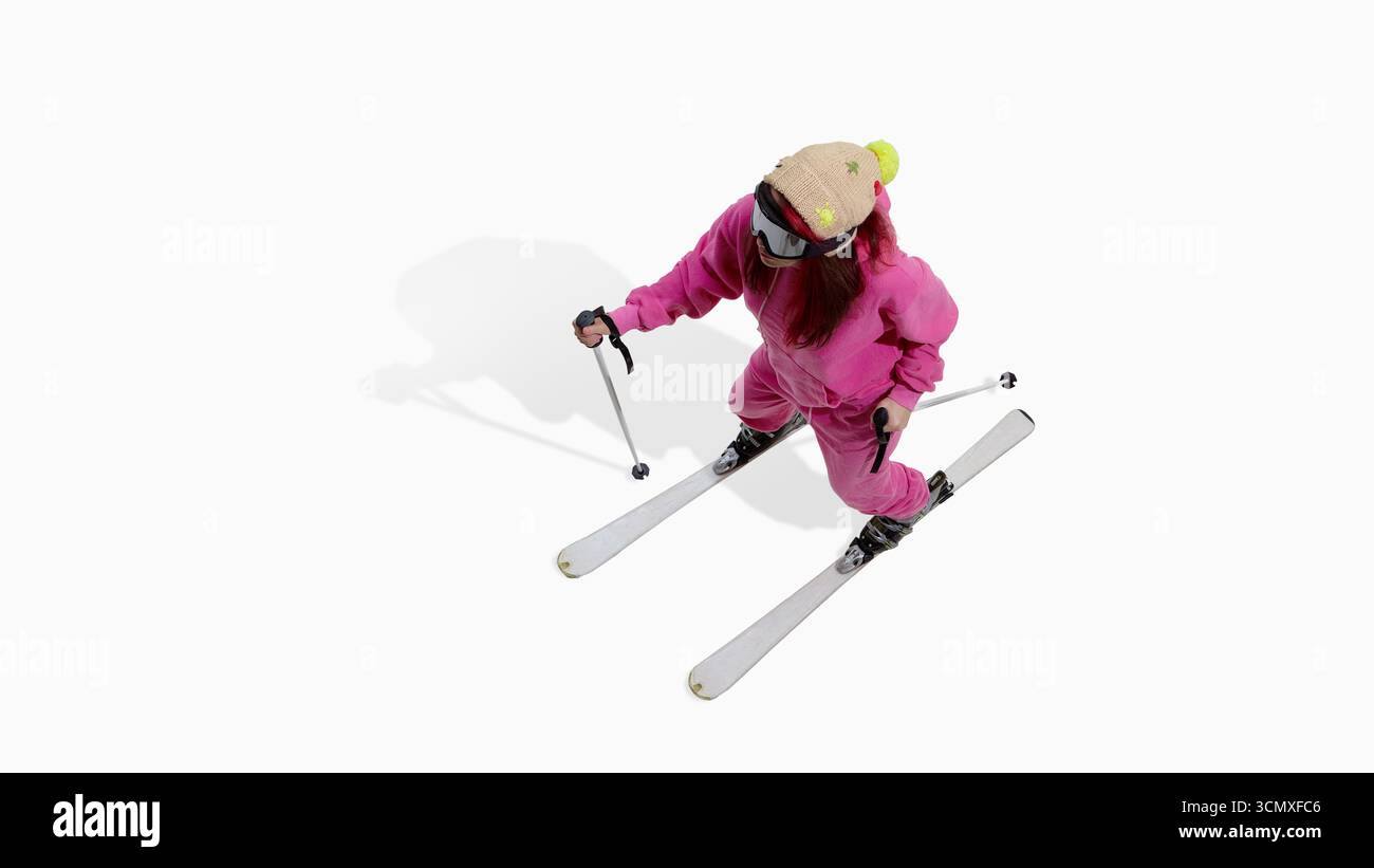 Skifahrer in rosa Outfit, der mit konstanter Entschlossenheit direkt abwärts fährt Stockfoto