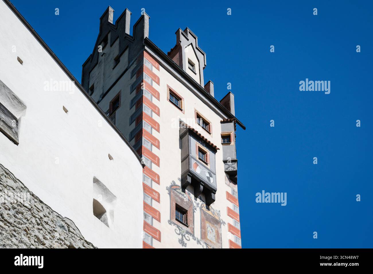 Gemalte Fassade auf dem Torturm und der Wehrmauer des Hochschlosses in Füssen in der Morgensonne, Bayern, Deutschland Stockfoto