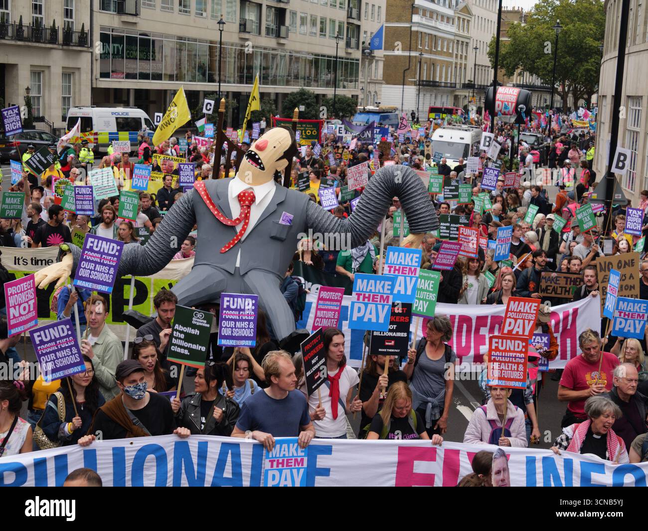 20. September 2025, Portland Place, London, Vereinigtes Königreich. Demonstranten mit Plakaten beim „Make They Pay“-marsch im Zentrum von London. Die Kampagne befasst sich mit Klimaungerechtigkeit und umfasst Demonstranten von Extinction Rebellion, Scientist Rebellion und Stay Grounded Stockfoto