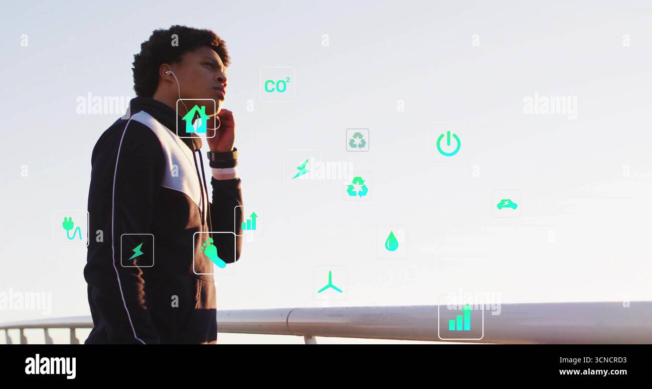 Angehaltener männlicher Läufer mit schwarzer Jacke am Pier-Geländer, schwebende Öko-Symbole, Kopierraum Stockfoto