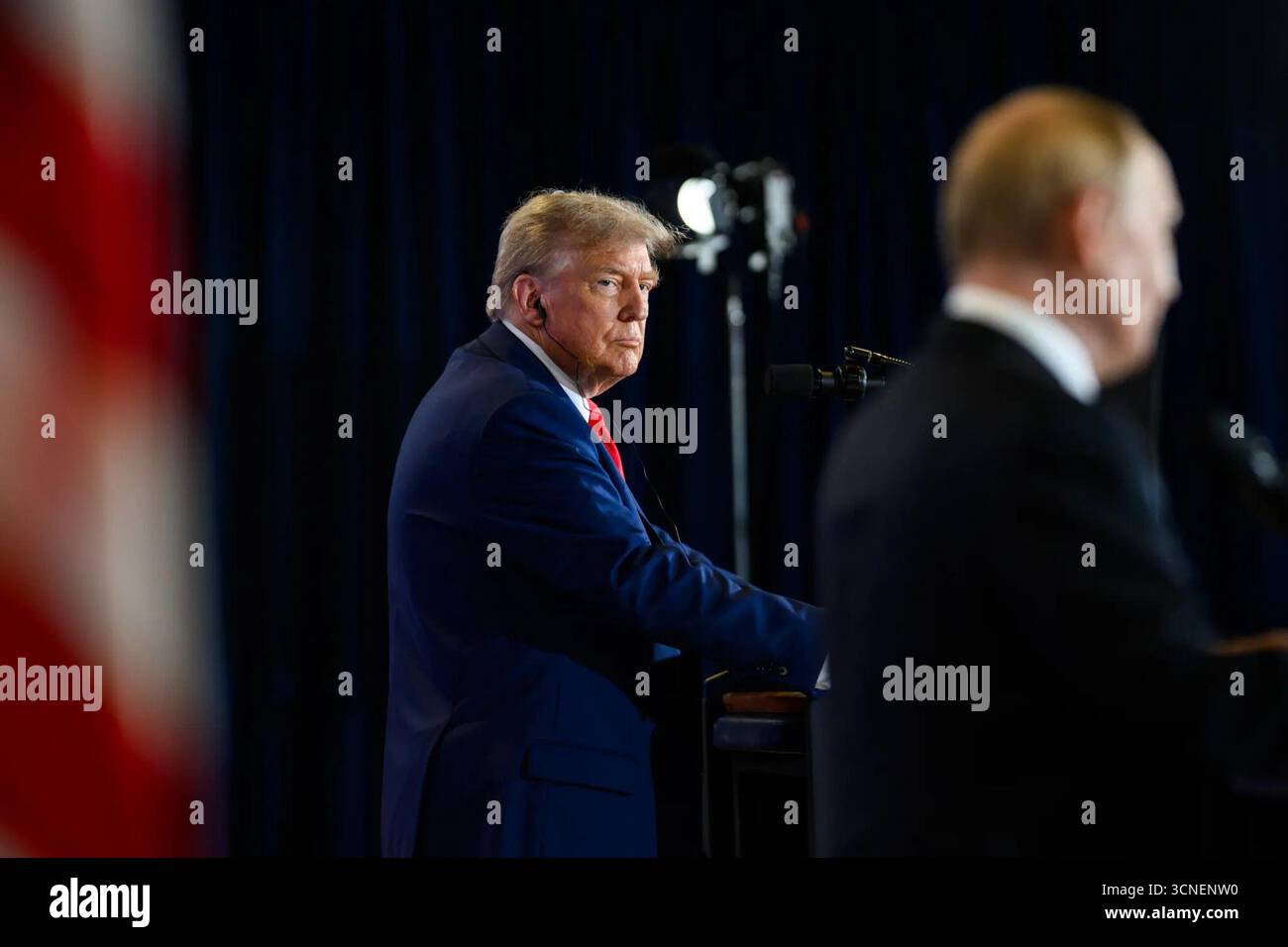 US-Präsident Donald J. Trump hört auf einer gemeinsamen Pressekonferenz mit dem russischen Präsidenten Wladimir Putin am 15. August 2025 auf der Joint Base Elmendorf-Richardson in Anchorage, Alaska. Auf dem Gipfel ging es um Verhandlungen über die Beendigung des Krieges in der Ukraine. Bild mit freundlicher Genehmigung des Weißen Hauses. Stockfoto
