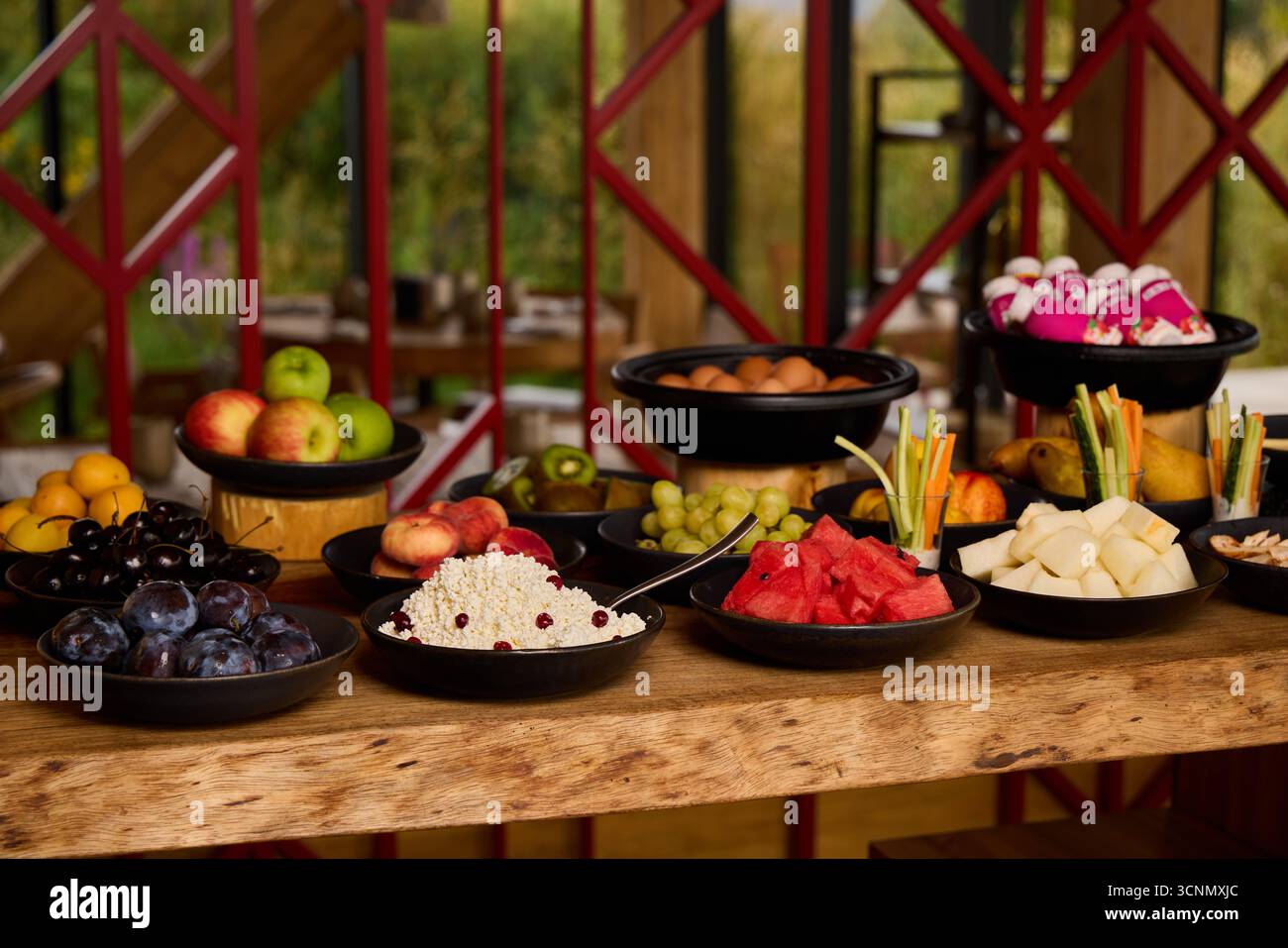 Obst- und Dessertpräsentation in einem gemütlichen Essbereich im Freien Stockfoto