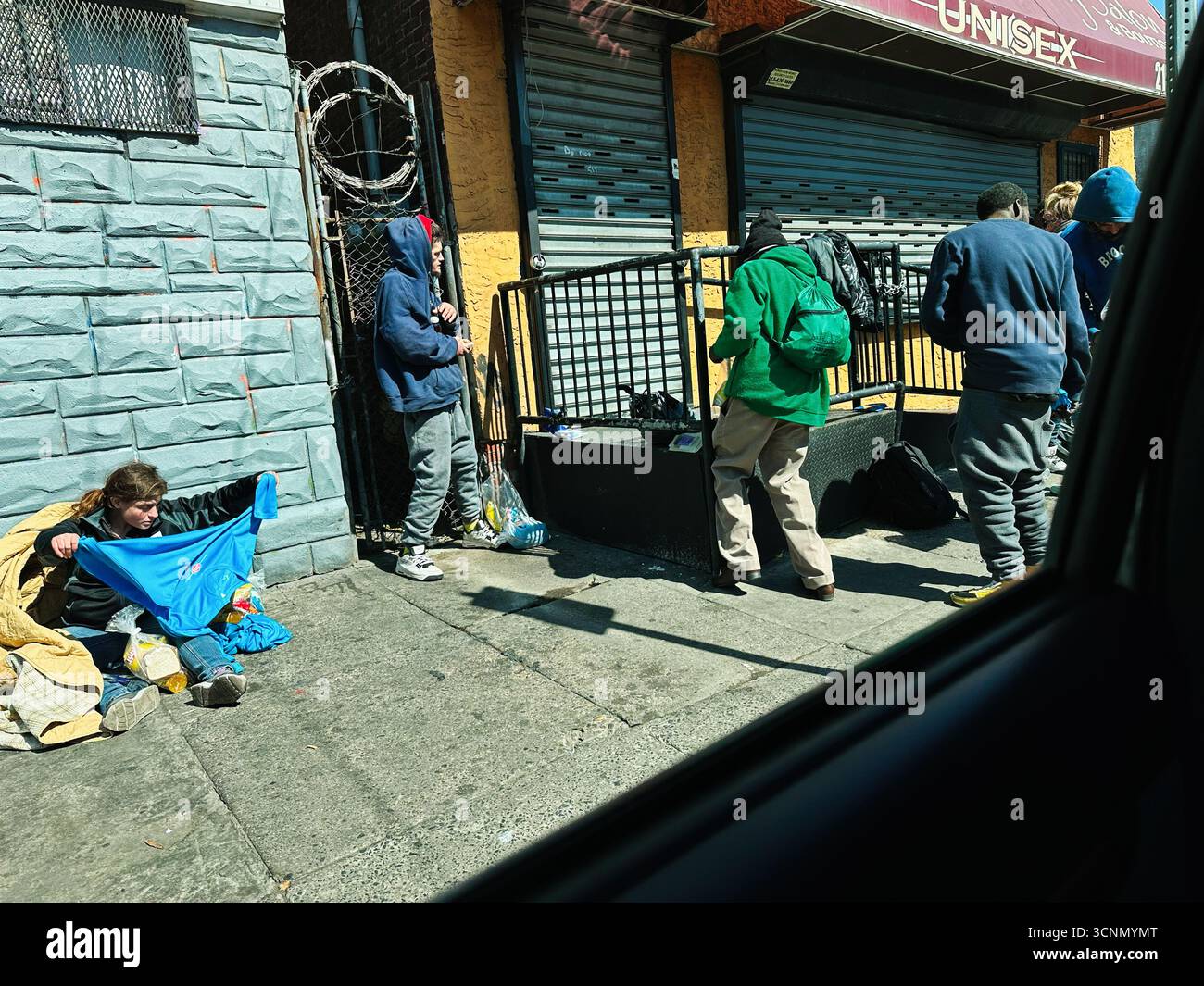 Philadelphia, Pennsylvania, USA - 29. April 2025: Die urbane Szene der obdachlosen Junkie versammelte sich in der Nähe eines geschlossenen Geschäfts in Zombieland, Kensington Ave, Phi Stockfoto