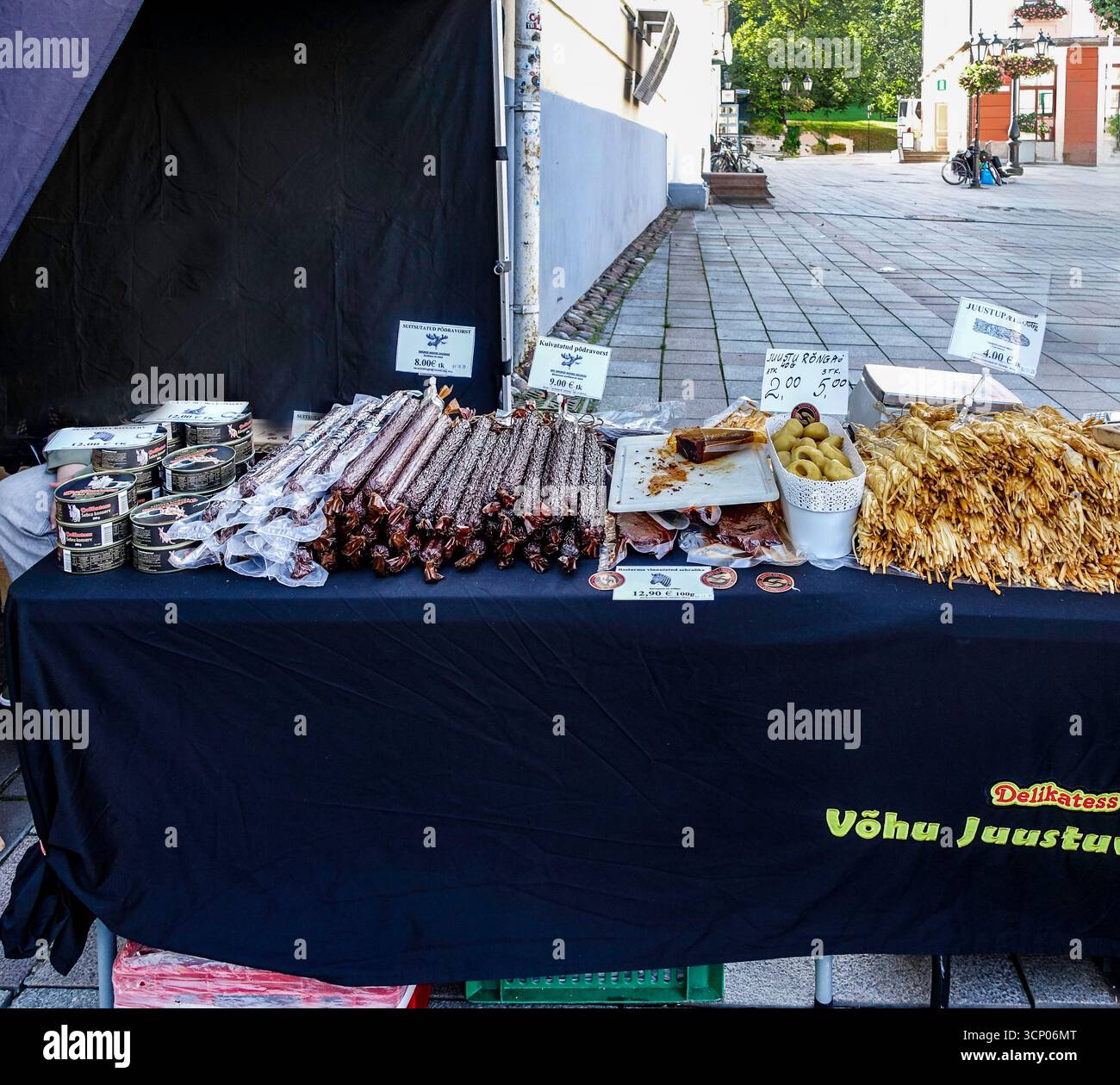 Wochenendmarktstand in Tartu, Estland, mit Räucherkäse, Würstchen und lokalen Köstlichkeiten, die baltische Esskultur und Tradition widerspiegeln. Stockfoto