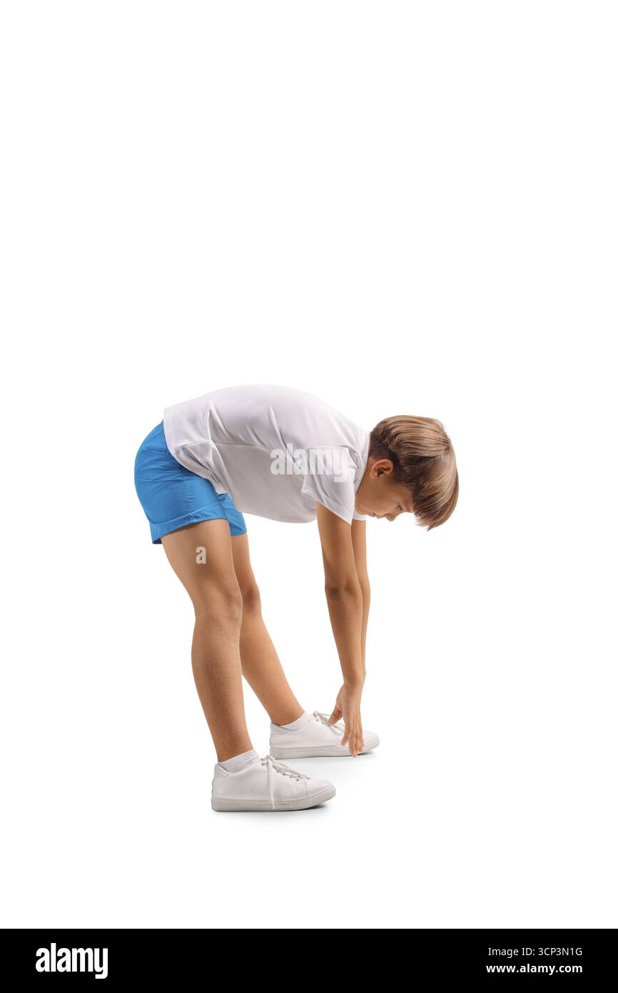 Profilaufnahme eines Jungen, der die Zehen streckt und berührt, isoliert auf weißem Hintergrund Stockfoto