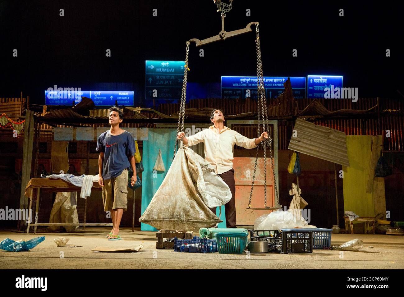 l-r: Hiran Abeysekera (Sunil Sharma), Shane Zaza (Abdul Husain) in BEHIND THE BEAUTIFUL FOREVERS von David Hare im Olivier Theatre, National Theatre (NT), London SE1 18/11/2014, basierend auf dem Buch von Katherine Boo Design: Katrina Lindsay Beleuchtung: Paule Constable Regie: Rufus Norris Stockfoto