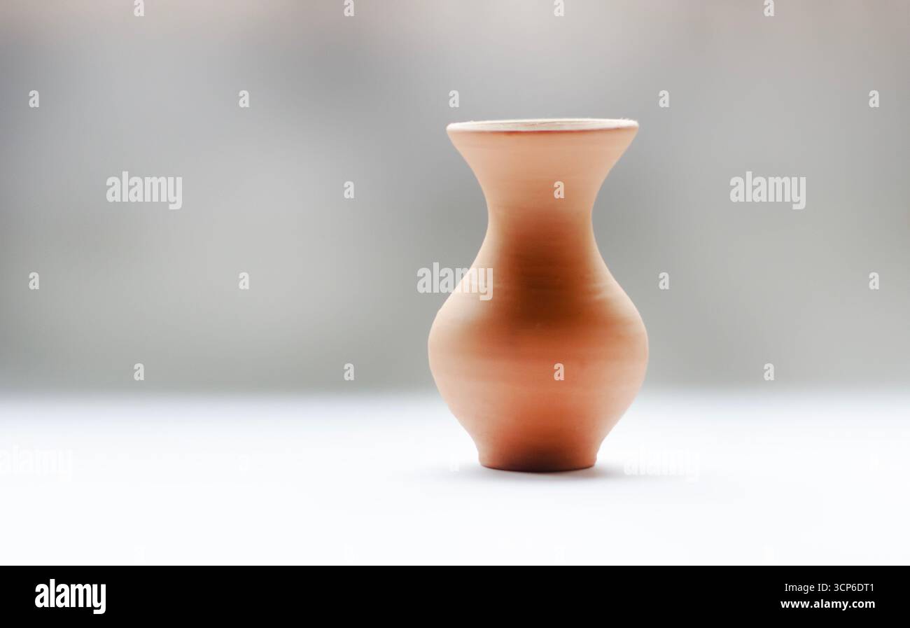 Ein minimalistischer Keramiktopf mit einzigartiger Form auf grauweißem Hintergrund ist ideal für moderne Wohnkultur und Inneneinrichtung. Stockfoto