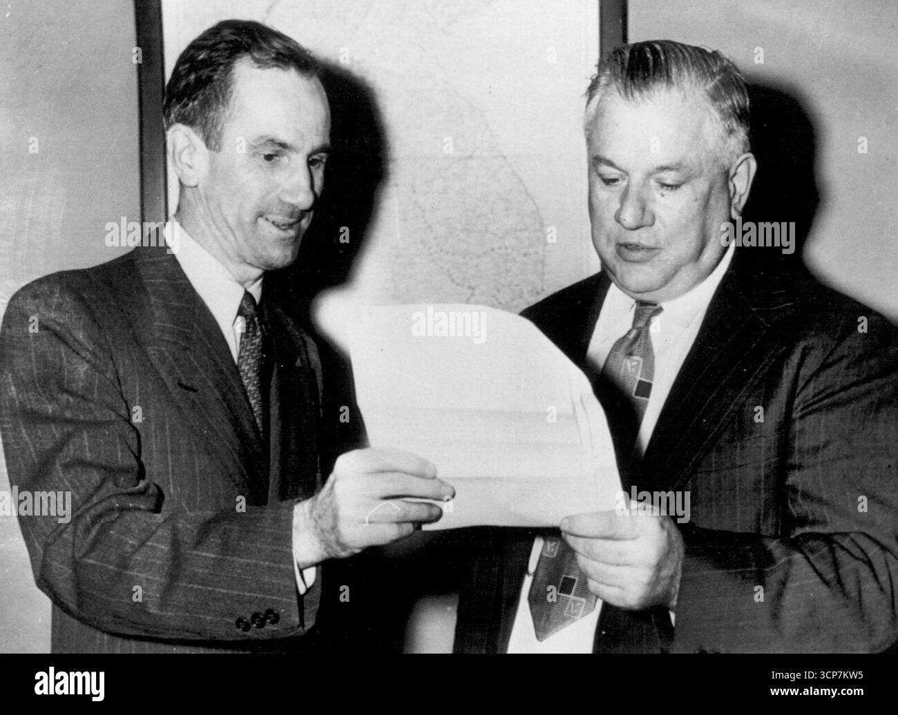 John C. Ross (links), stellvertretender Vertreter der Vereinten Nationen, übergibt heute dem stellvertretenden UN-Generalsekretär Cordier hier eine Kopie von General MacArthurs Botschaft, in der die Nordkoreaner aufgefordert werden, bedingungslos der Gesichtszerstörung durch UN-Truppen aufzugeben, jetzt am 38. Breitengrad. Cordier erhielt die Nachricht für UN-Generalsekretär Trygve Lie. 30. September 1950. (Foto von AP Wirephoto). Stockfoto