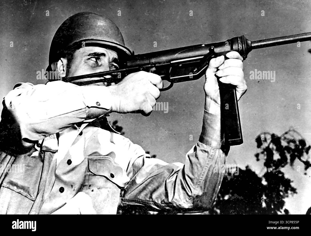 Neue Maschinenpistole der Armee -- Corporal Lloyd W. Ricketts aus Fort Myer, VA., hält die neue M-3 Maschinenpistole der US Army, die sich als tödliche Waffe gegen den Feind erweist. Diese neue Waffe wurde vom Ordnance Department entwickelt und ist klein genug, um sie in einem gewöhnlichen, kurzen Koffer tragen zu können. Sie ist jedoch so robust, dass eine der M-3 nach einem Testabfeuer von 49.600 Schuss die Genauigkeit verbesserte, anstatt sie zu verlieren. Es ist eine Waffe des Kalibers 45 und wiegt weniger als 9 Pfund im Vergleich zu dem Gewicht der berühmten Thompson-Maschinenpistole. März 1943. (Foto: U.S. Army Photo). Stockfoto