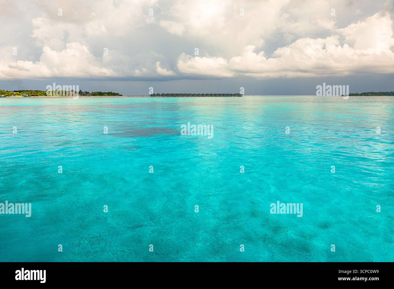 Ruhiger und ruhiger Hintergrund mit bedeckter tropischer Meeresbucht. Ruhiges Wasser, sanfter bewölkter Himmel, friedliche Aussicht auf die Natur. Meereslandschaft Stockfoto