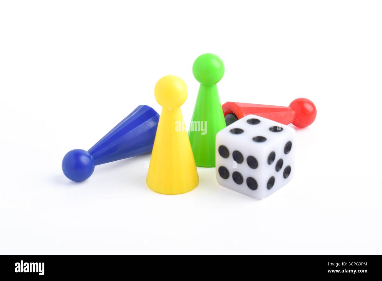 Bunte Brettspiel-Figuren und Würfel isoliert auf weißem Hintergrund Stockfoto