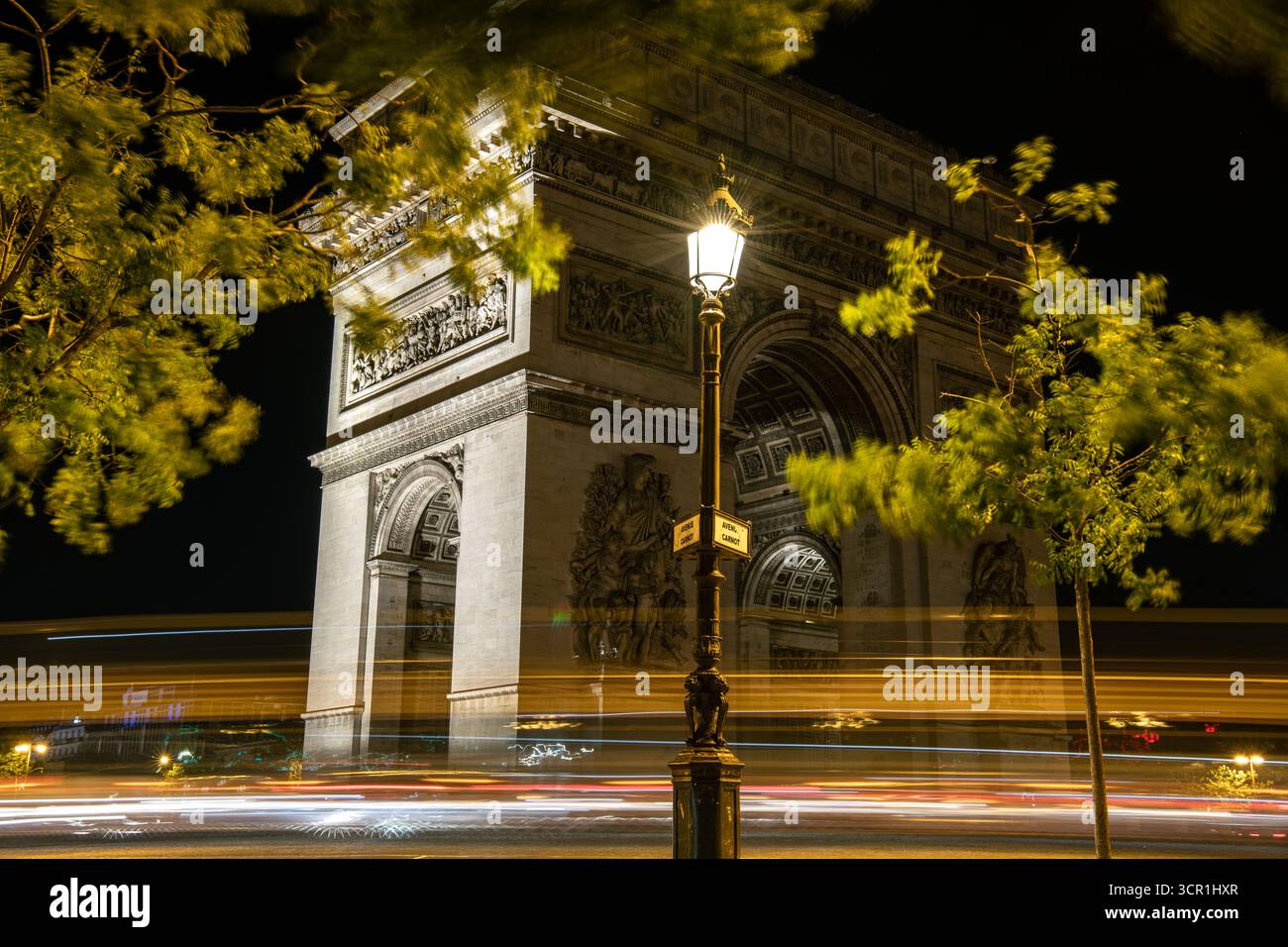 Leichte Wege rund um den Arc de Triomphe bei Nacht - Paris, Frankreich Stockfoto