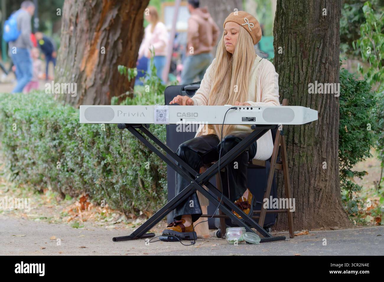Mädchen spielt eine elektronische Tastatur im Park Stockfoto