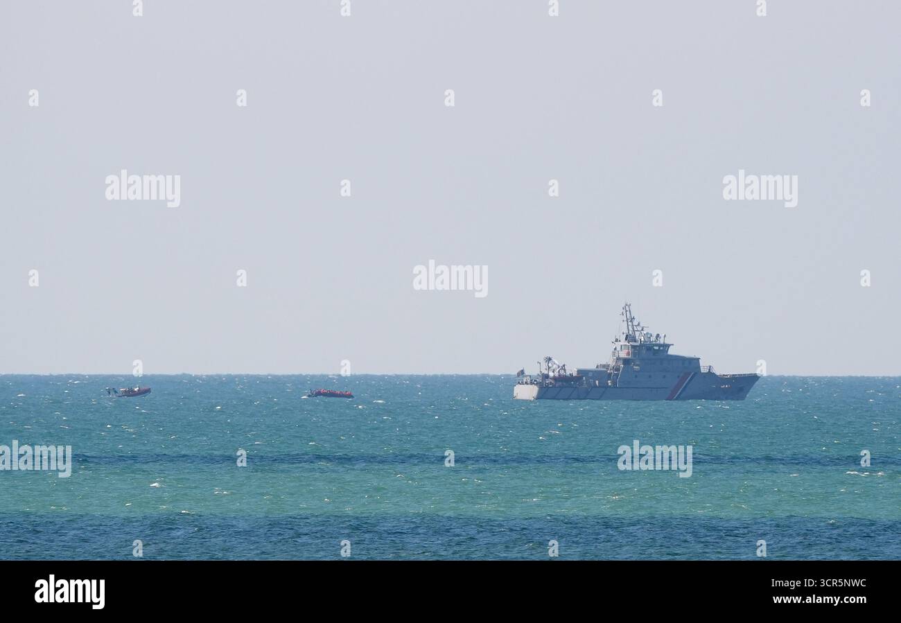 Ein kleines Boot mit Personen, die als Migranten gelten, wird von den französischen Behörden begleitet, als es die Küste in Boulogne in Frankreich verlässt. Bilddatum: Montag, 29. September 2025. Stockfoto