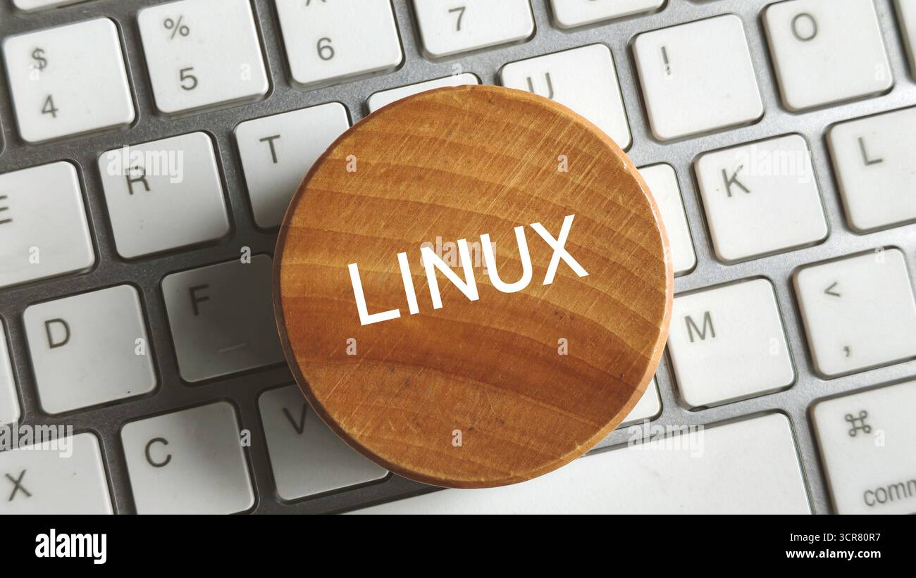 Nahaufnahme von Wooden Circle mit LINUX-Text auf Computer-Tastaturtasten für Open-Source-OS-Konzept Stockfoto