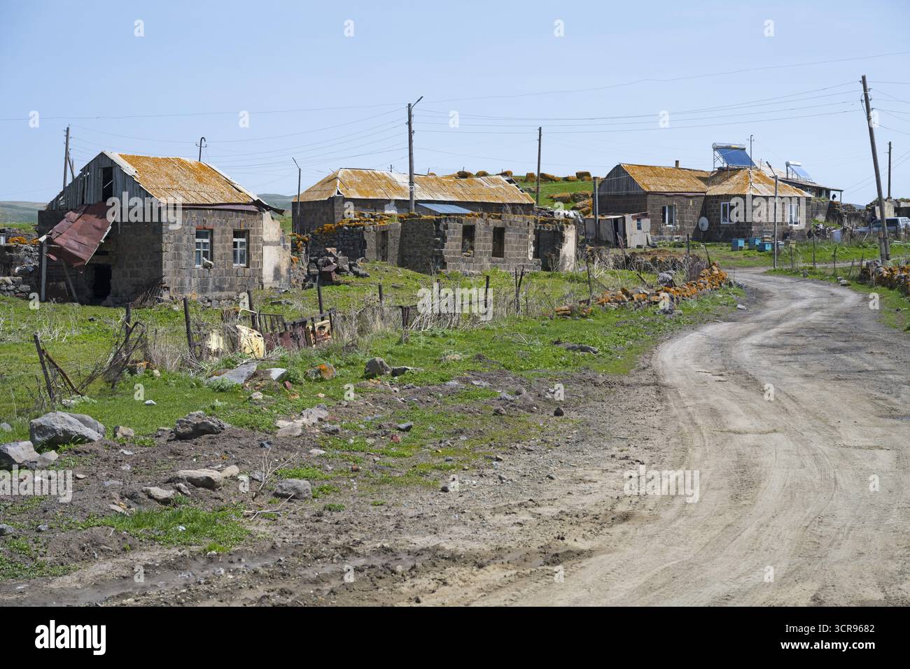 Ruhiges Dorf mit alten Gebäuden entlang einer unbefestigten Straße in einer grünen Landschaft, Berdashen, Arpi-See, Shirak-Provinz, Armenien Stockfoto