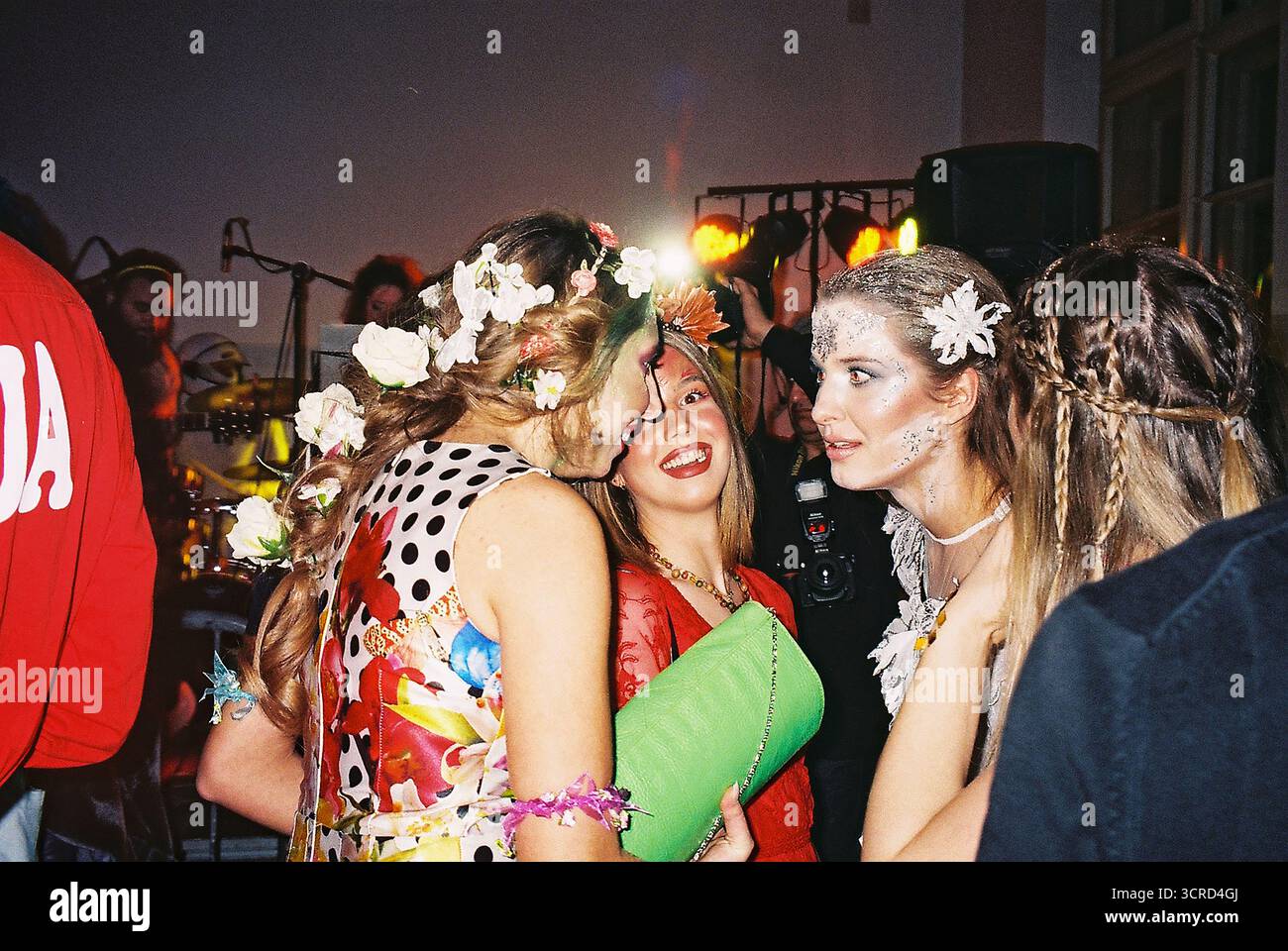 35mm Farbfilmfoto einer Studentenkostümparty an einer Universität in Belgrad. Blitzlicht, chaotisch, unterhaltsam, raue Energie – analoge Nightlife-Momentaufnahme. Stockfoto