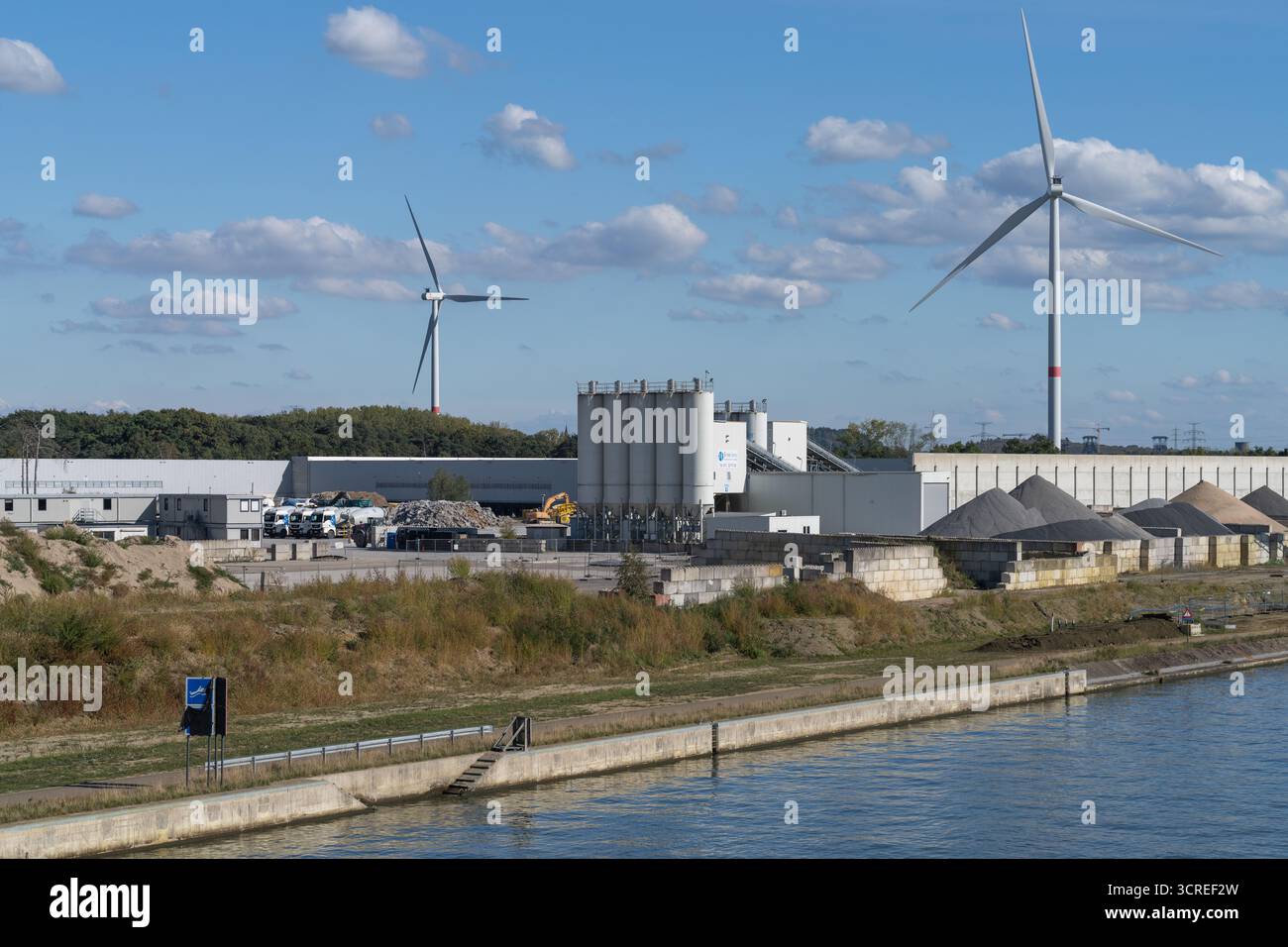B-Mix Beton Produktionsanlage mit Silos und Windturbinen entlang des Kanals in Tessenderlo, Tessnederlo-Ham, Limburg, Belgien Stockfoto
