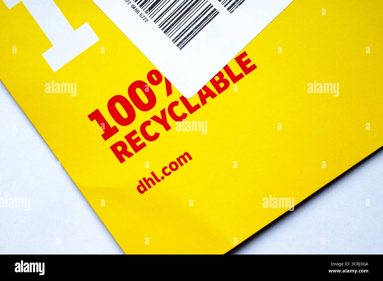 Itterbeck, Deutschland - 4. September 2025 Detail eines gelben Expressumschlags von DHL. Er ist zu 100 % recycelbar. Stockfoto