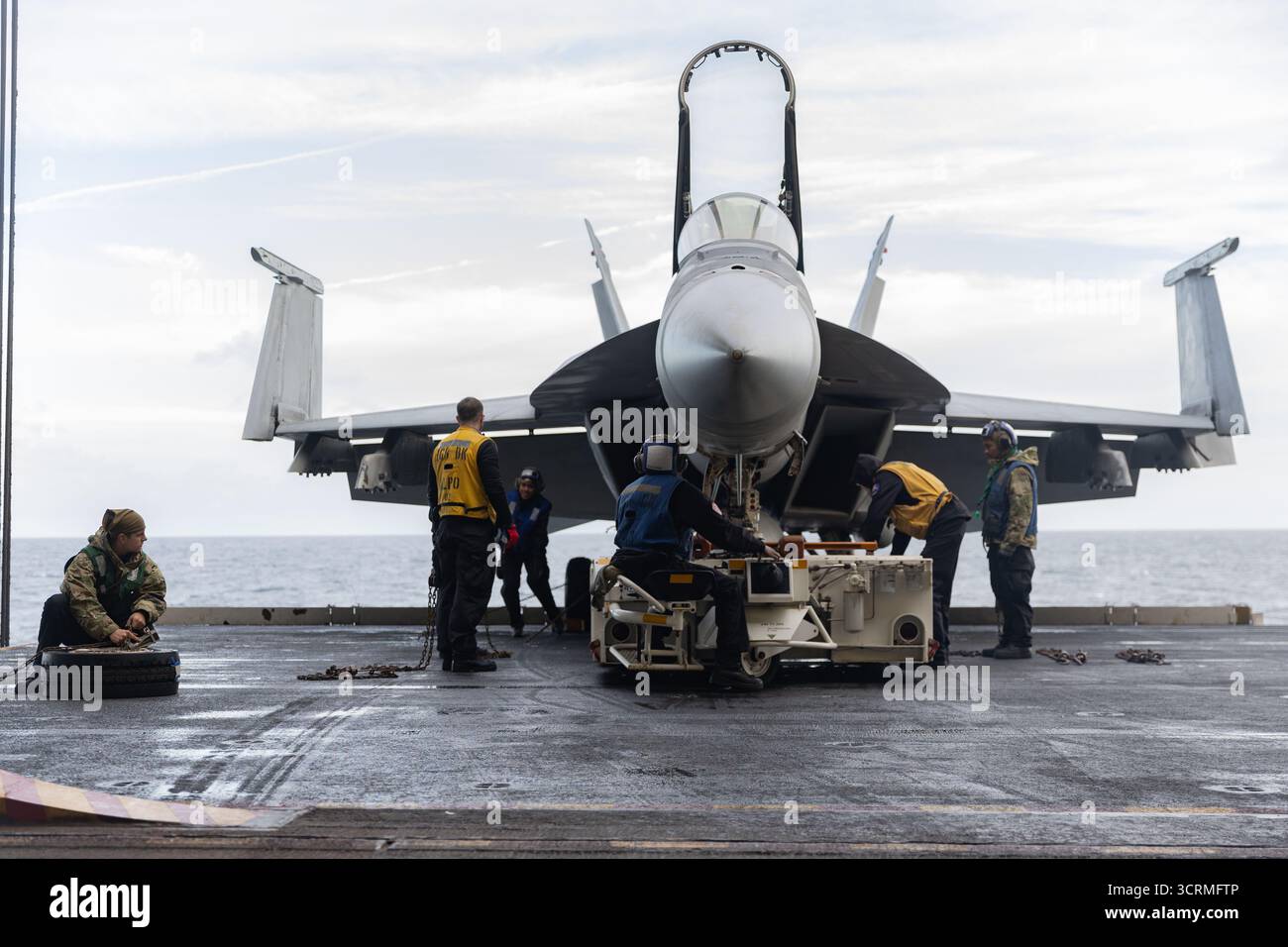 Seeleute, die dem Air Department an Bord des weltweit größten Flugzeugträgers, USS Gerald R. Ford (CVN 78), zugewiesen sind, sichern eine F/A-18E Super Hornet Stockfoto