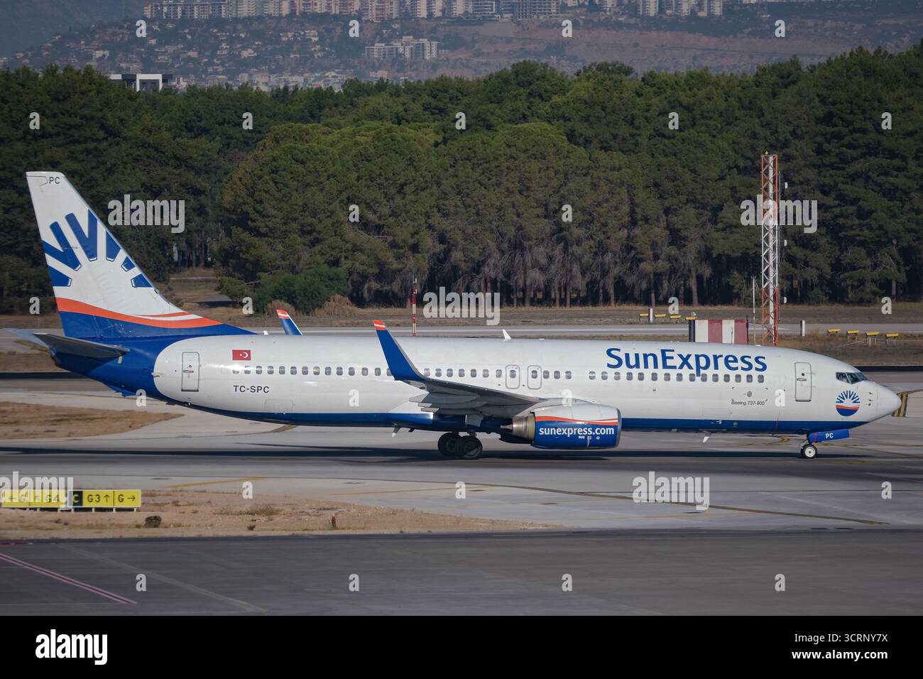 SunExpress Boeing 737 fährt am Flughafen Antalya, Türkei, mit dem Geschäftsjet auf dem Flughafentransfer. Stockfoto
