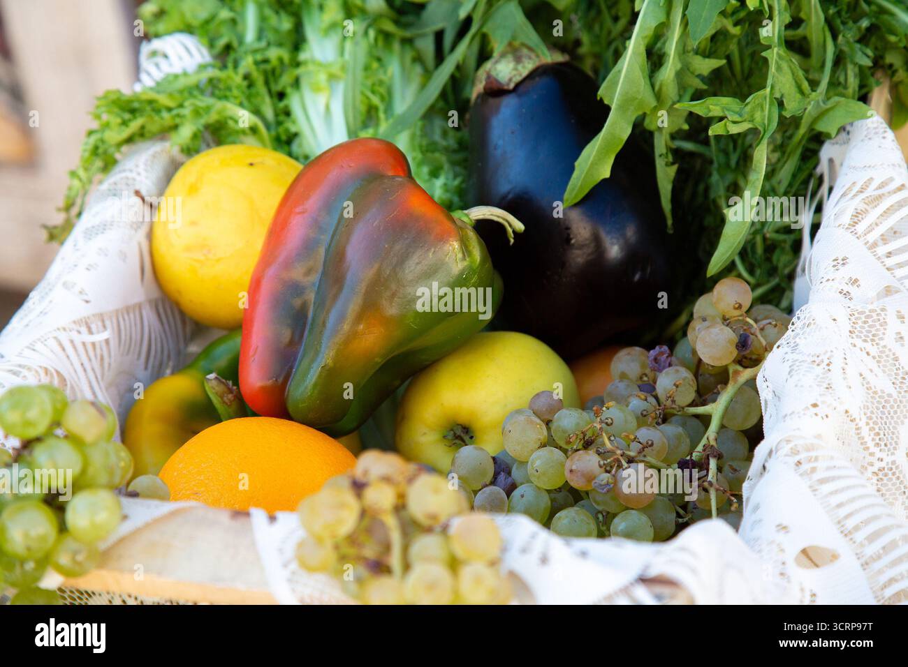 Ein Korb mit Obst und Gemüse, einschließlich Paprika und Trauben Stockfoto