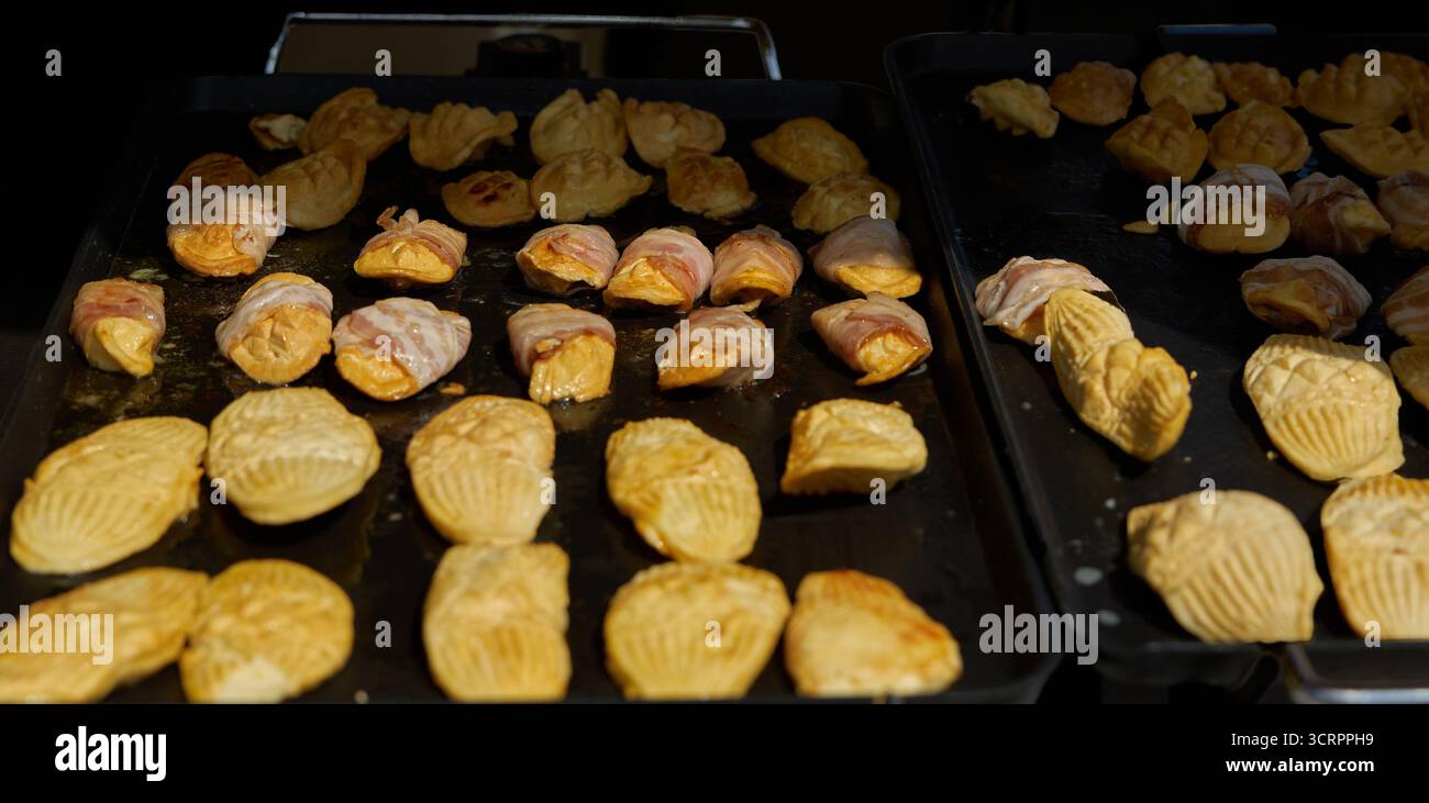 Street Food, Brötchen aus Teig auf einem Backblech auf dem Marktplatz. Krakau, Polen, Rynek Glowny. Stockfoto