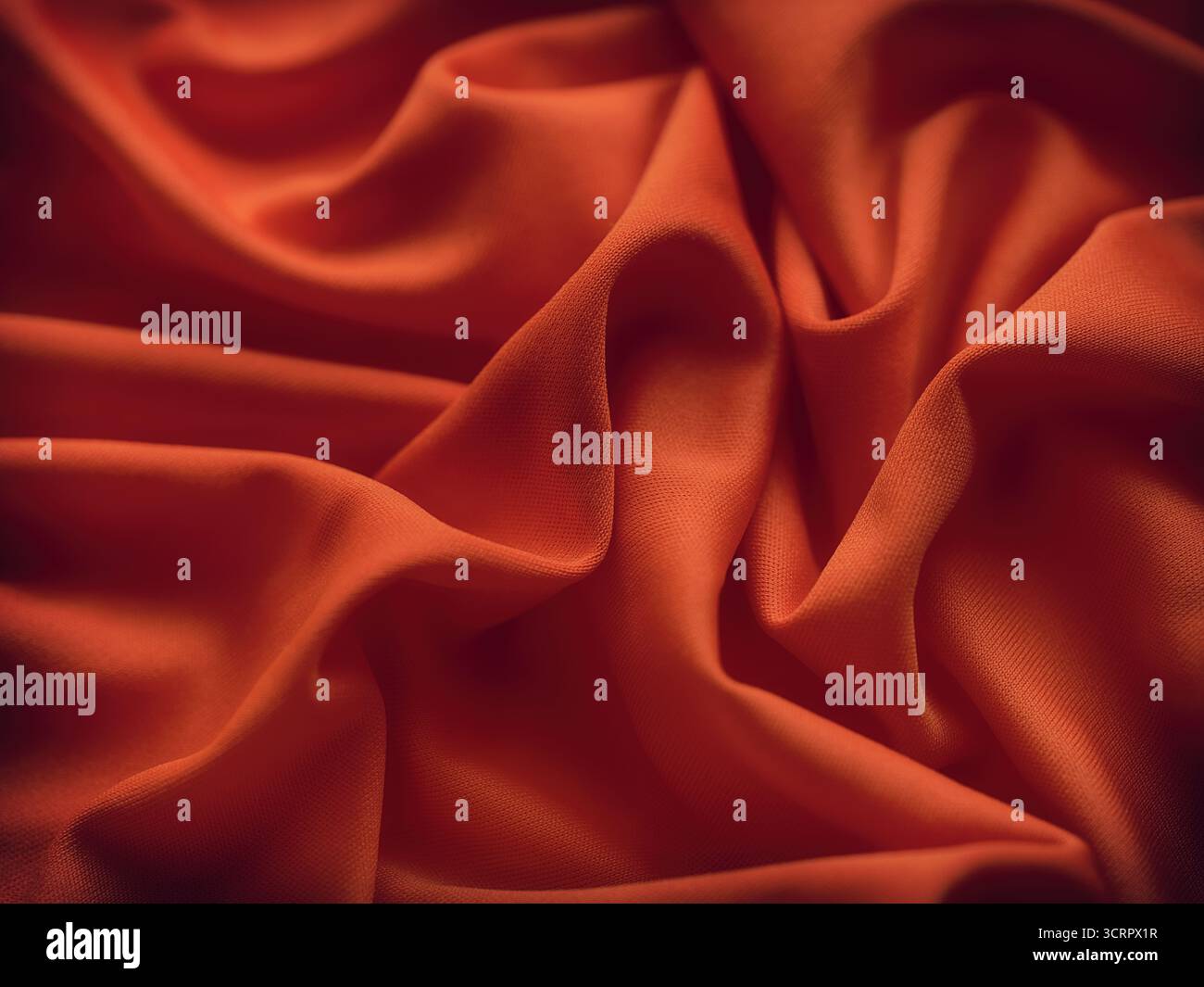 Ein rötlich-oranger Hintergrund mit faltiger Textur. Nahaufnahme. Stockfoto