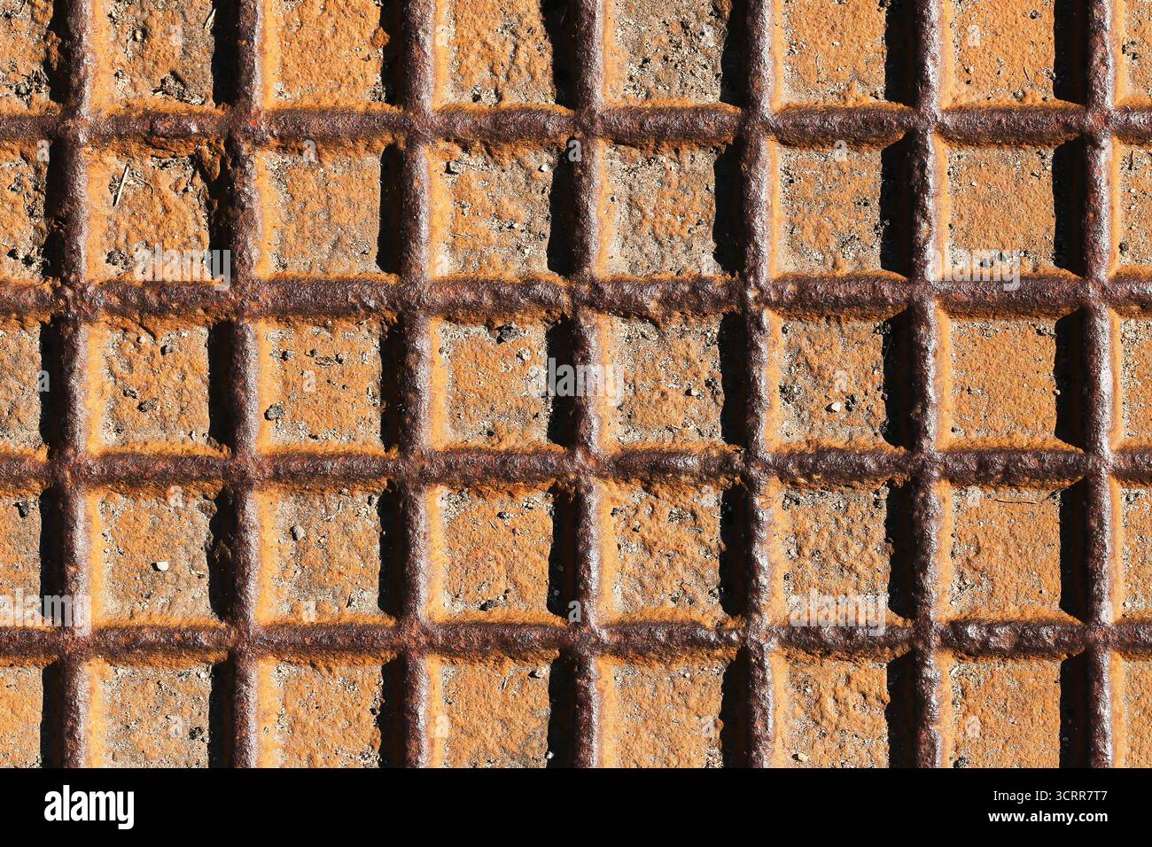 Rostiges Metallgittermuster in Nahaufnahme. Hintergrund mit industriellem Muster mit verwitterter Stahloberfläche und geometrischen Konstruktionsdetails im Freien. Stockfoto