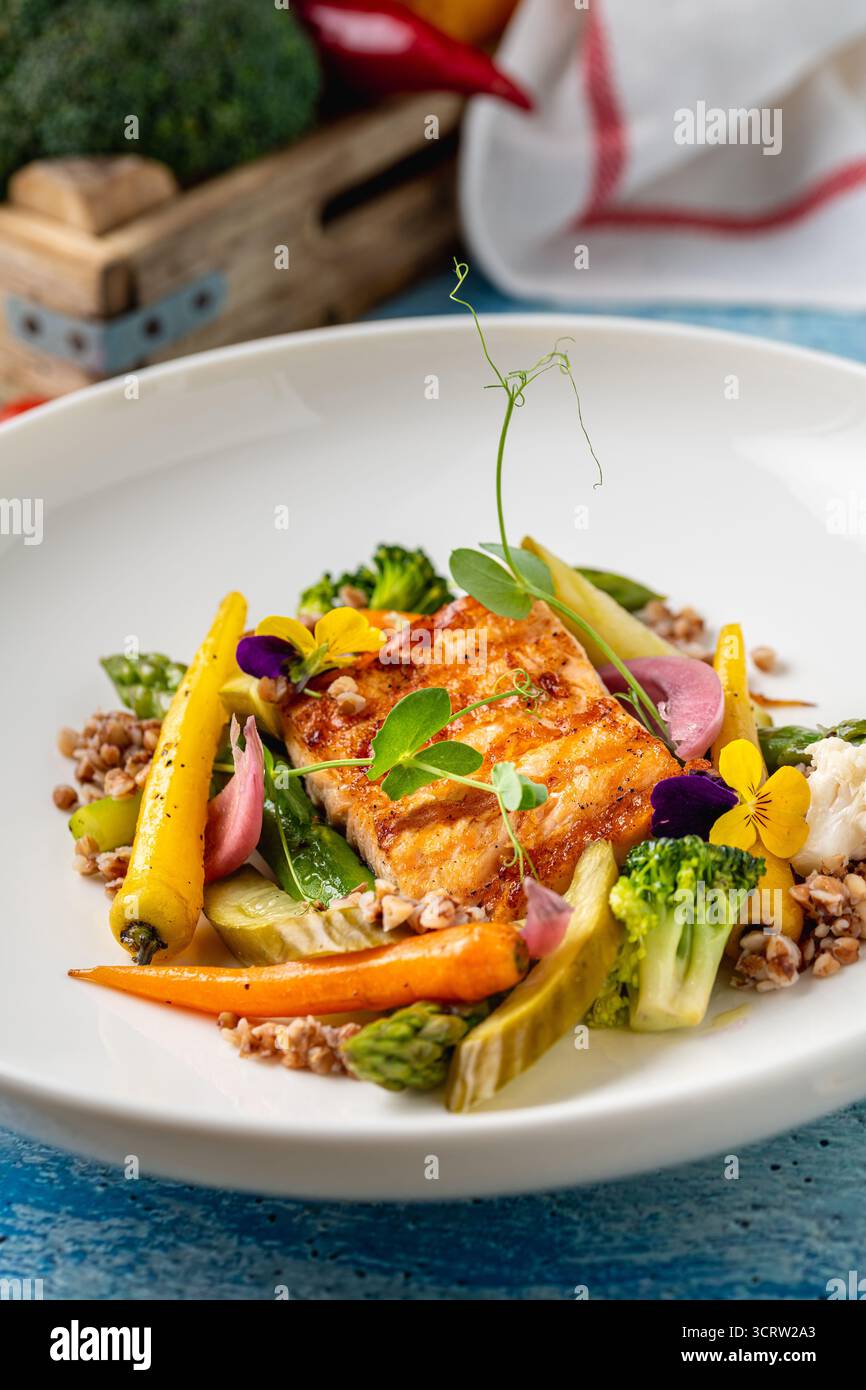 Gebratenes Lachsfilet mit Getreide und Gemüse der Saison Stockfoto