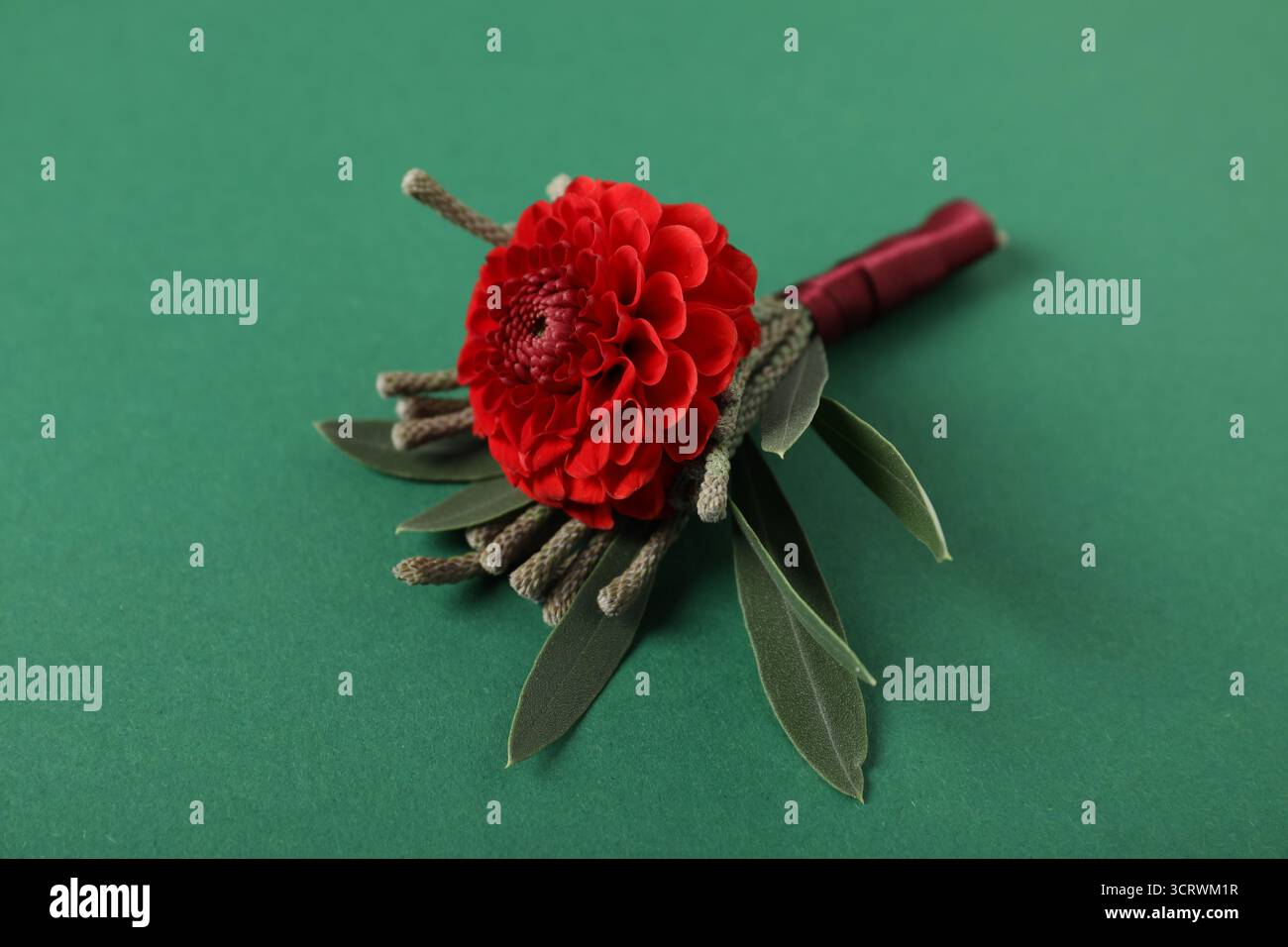 Stilvolle Boutonniere mit Blume auf grünem Hintergrund, Nahaufnahme Stockfoto