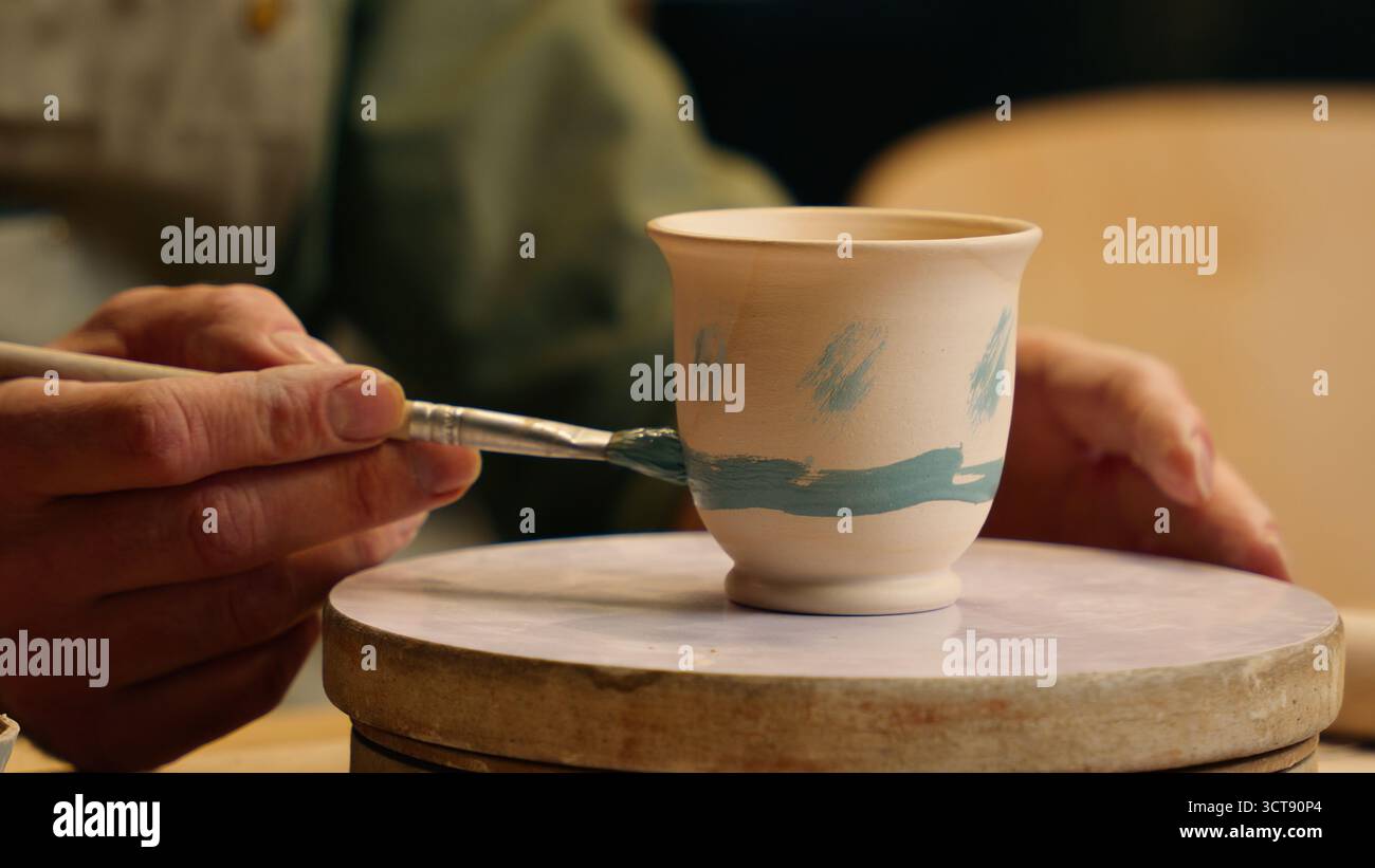 Nahaufnahme unbekannter kaukasischer Mann männliche Hände kleiner Geschäftsinhaber Töpfer Unternehmer Geschäftsmann Malerei Keramik Ton Vase Topf Zeichnung Pinsel Stockfoto