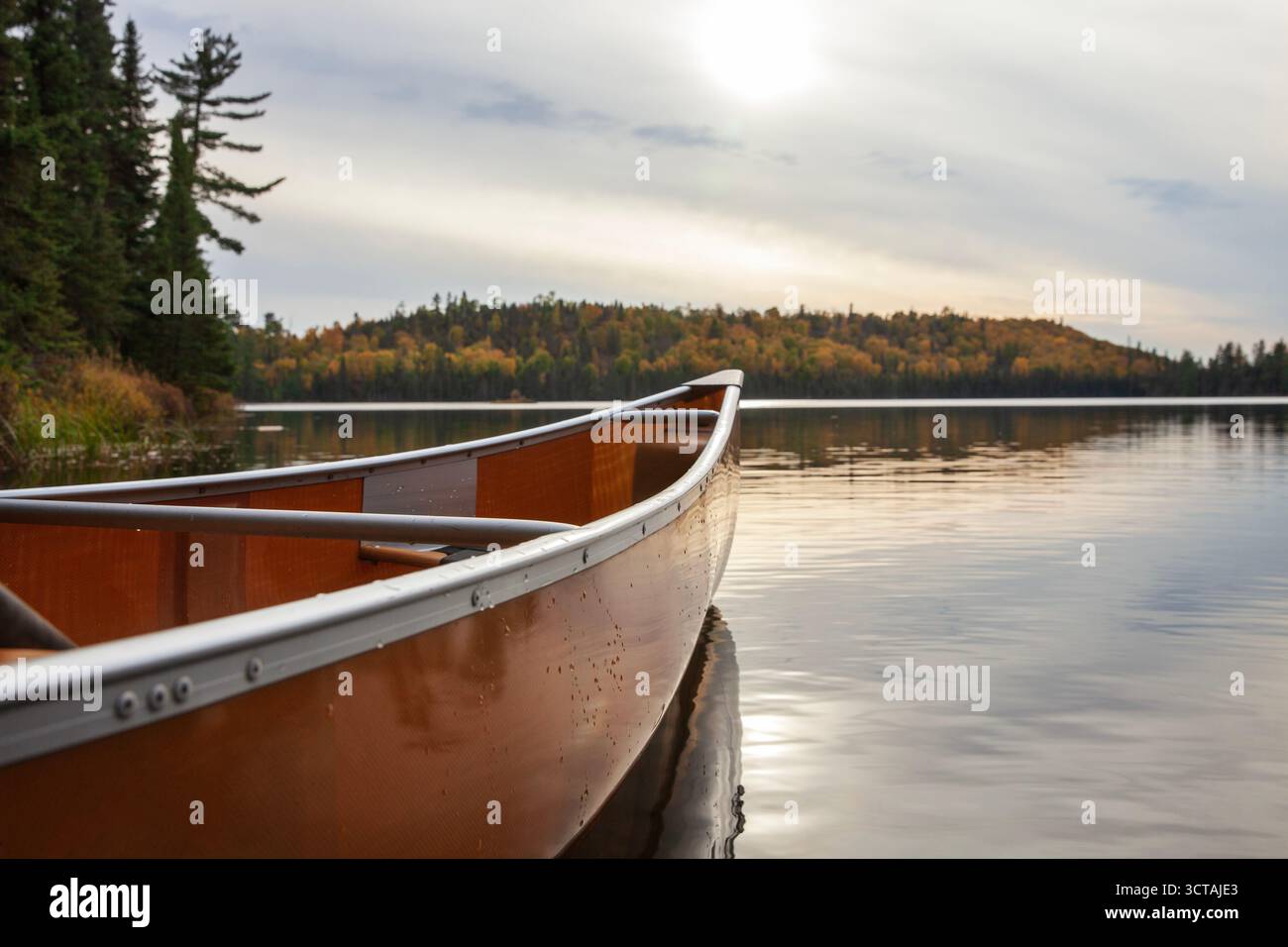 Ultraleichtes Kanu mit niedrigem Winkel selektiver Fokus auf einem Boundary Waters Forellensee an einem bewölkten Herbsttag Stockfoto