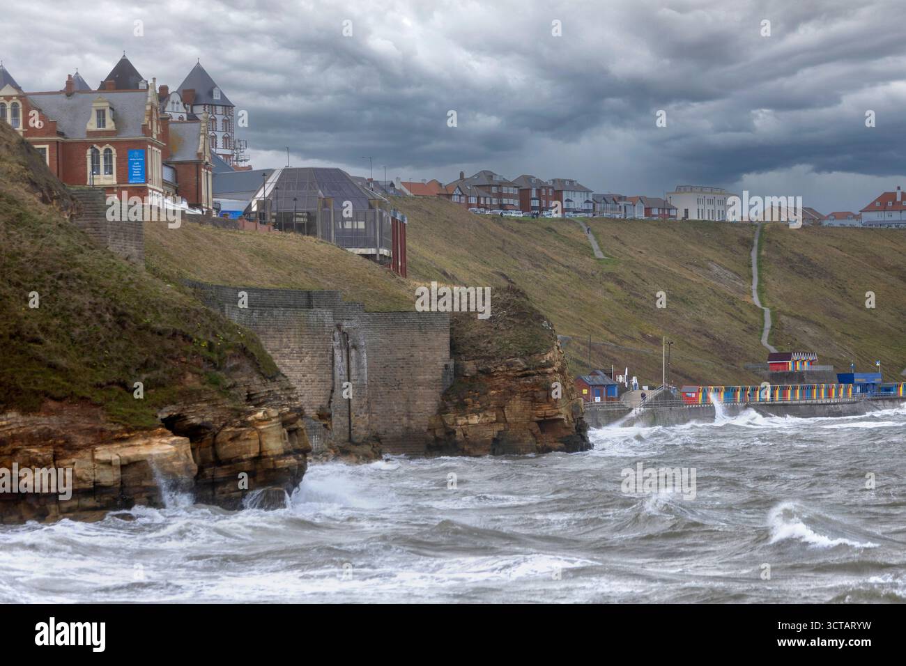 Sturm Amy bringt starke Westwinde und Wetter an die Küste von Yorkshire, die das Meer und die Wellen auf Whitby Küste und Strand entlang des Piers aufsaugen Stockfoto