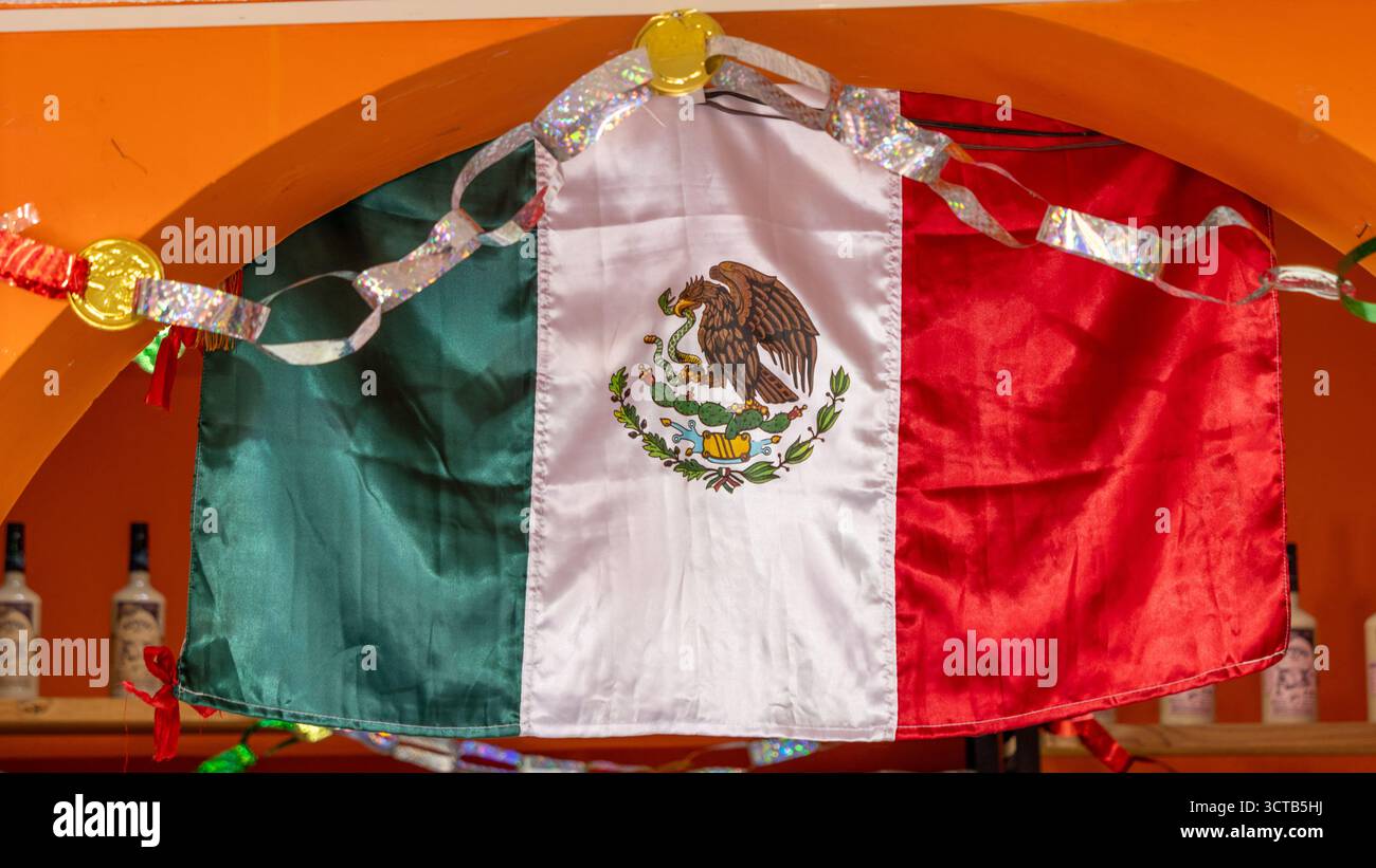 Eine mexikanische Flagge hängt an einer Wand. Die Flagge ist rot, weiß und grün. Historisches Zentrum von Queretaro, Kolonialarchitektur, Dekorationen für das Haus Stockfoto