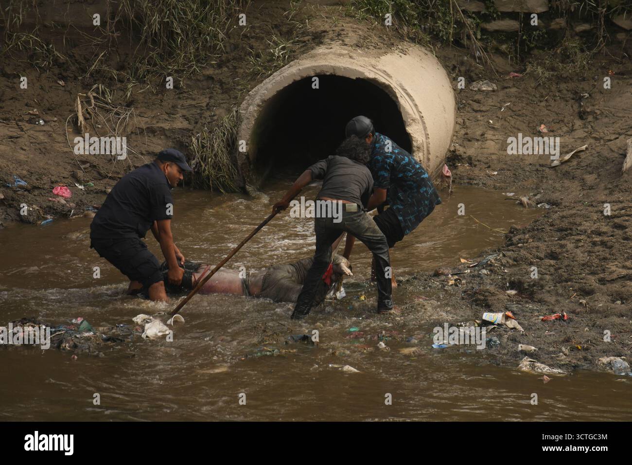 Kathmandu, Nepal. 7. Oktober 2025. Nepal Polizei und Einheimische haben am 7. Oktober 2025 eine unbekannte Leiche aus dem Zusammenfluss der Flüsse Bagmati und Bishnumati in Kathmandu nach schweren Regenfällen, die zu Überschwemmungen führten, gefunden. Steigende Wasserstände hatten Straßen, Häuser und Märkte in der Nähe gefährdet. Die Leiche wurde geborgen, als das Wasser zurückging. Untersuchungen über die Todesursache sind im Gange. Foto: Safal Prakash Shrestha Credit: Safal Prakash Shrestha/Alamy Live News Stockfoto