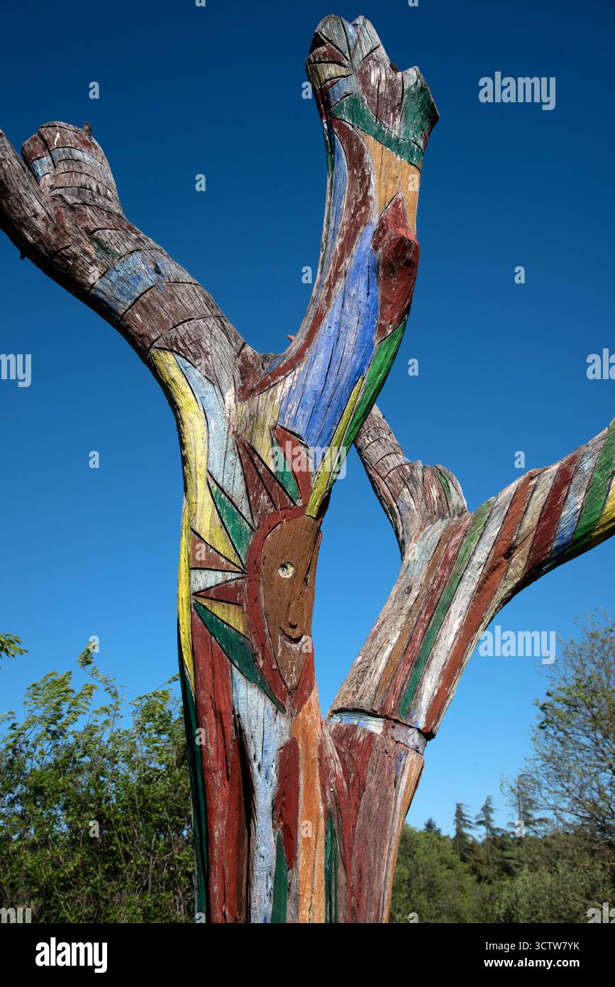 Dead Tree dekoriert oder gemalt in abstrakten Designs & Face to Create Art Tree oder Natural Street Art oder Public Art Goult Provence France Stockfoto