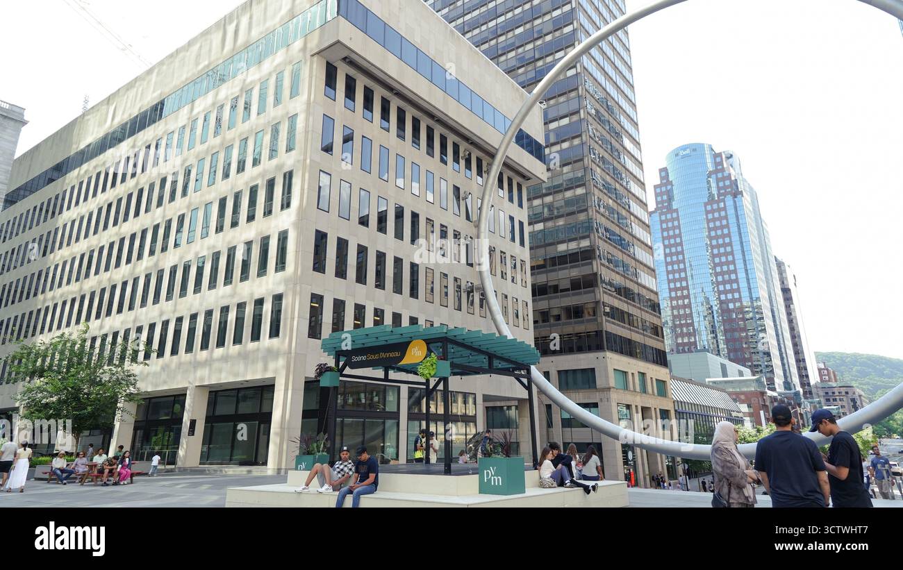 Montreal QC, Kanada - 20. Juli 2025: Die Ringskulptur am Place Ville Marie in Montreal, umrahmt von zeitgenössischen Gebäuden und lebhaften urbanen Aktivitäten Stockfoto
