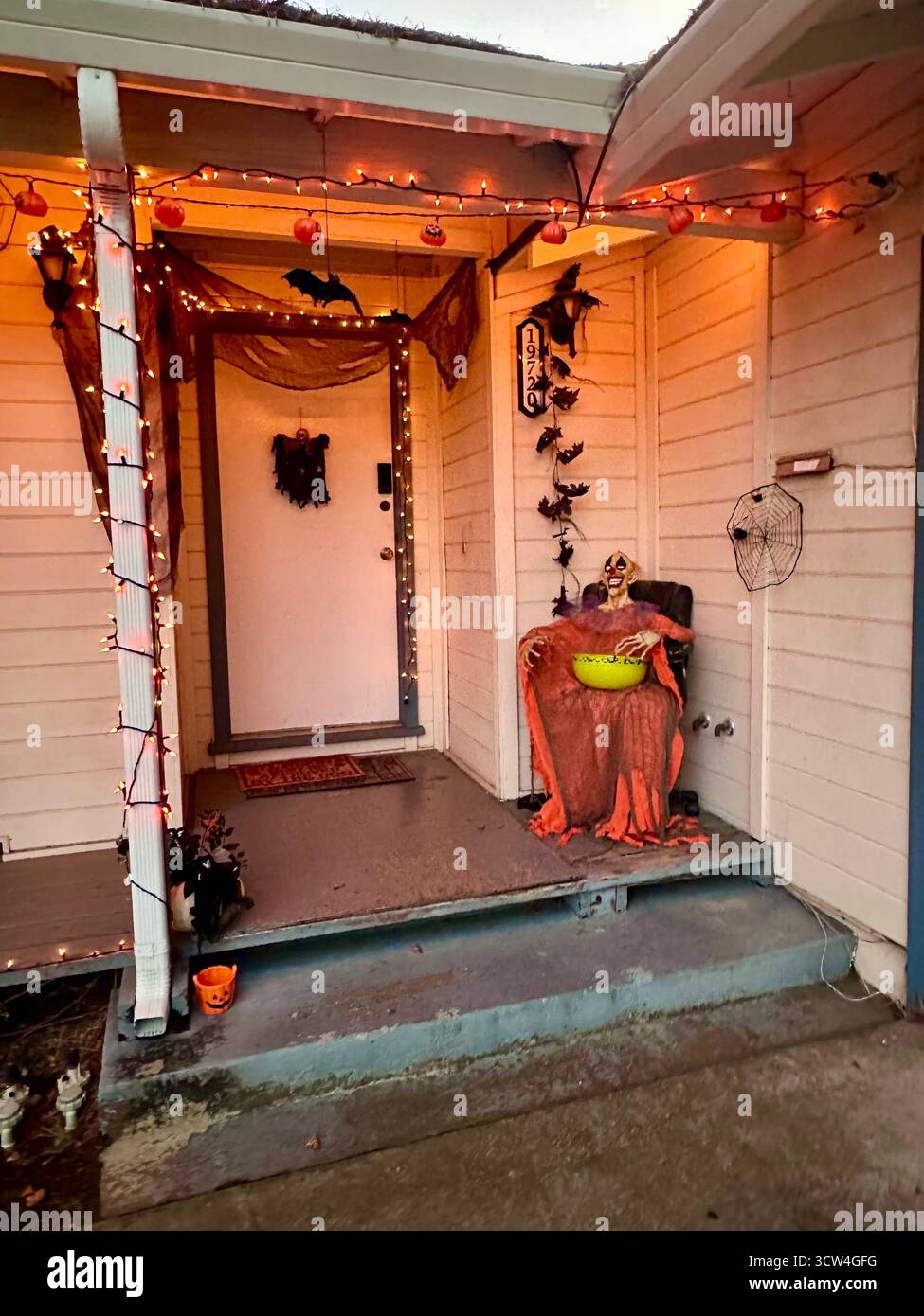 Halloween-Veranda mit Skelett Candy Holder und Kürbislichtern - Smartphone-aufgenommenes Stockfoto