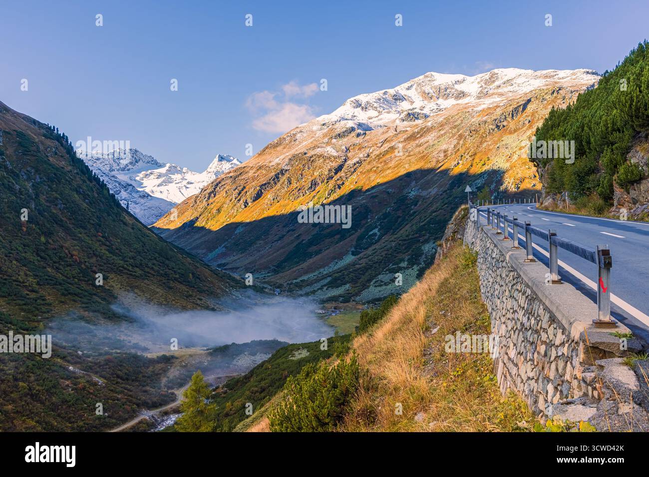 Landschaftsaufnahme des Unterengadin in Graubünden, Schweiz, aufgenommen im Spätherbst. Morgennebel füllt das Tal, während die Stockfoto