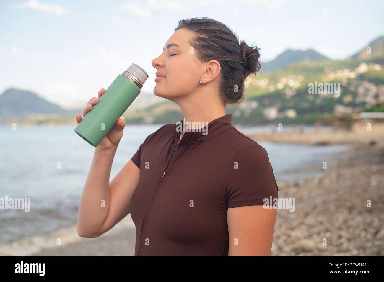 Outdoor Fitness Morning Workout am Strand Hydration und Energie fördern gesunden aktiven Lebensstil Stockfoto